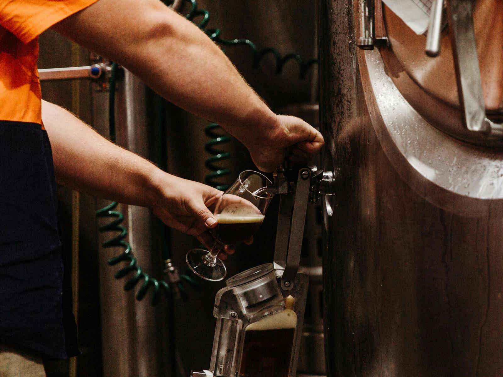 Beer being poured from a tank into a glass