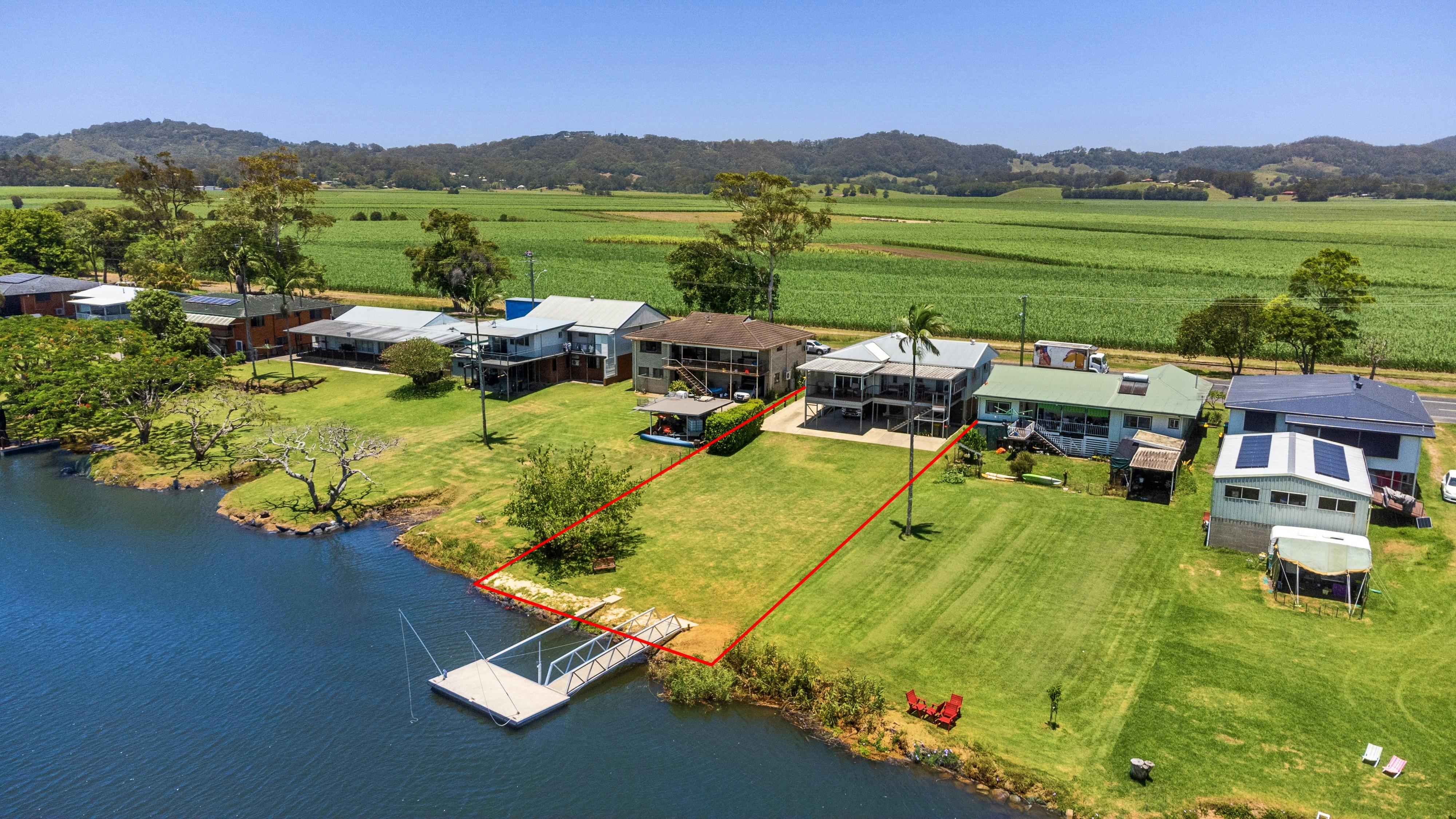 Two storey home with 18m river frontage, large grassy yard and private boat pontoon