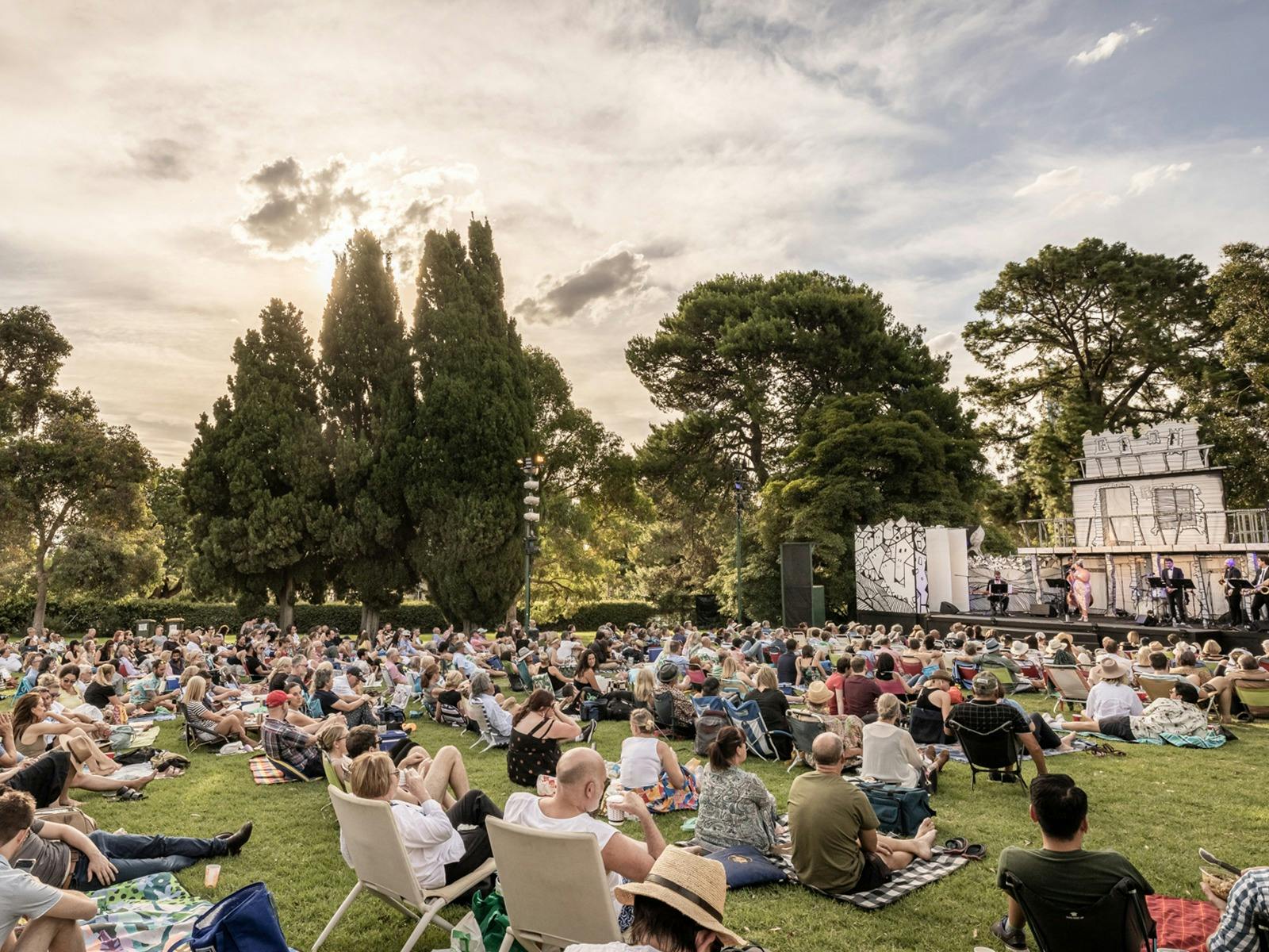 Audience seated picnic-style at Mozart by Moonlight, Royal Botanic Gardens, daytime.