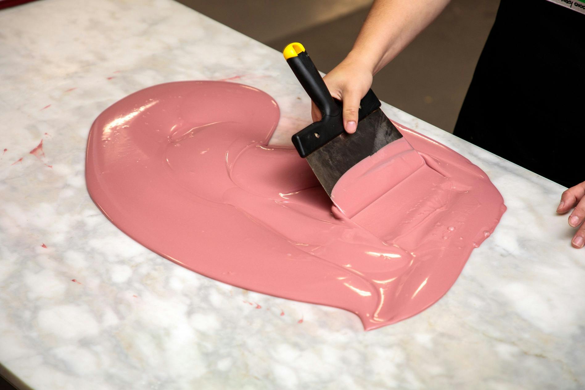 Ruby chocolate being created on table