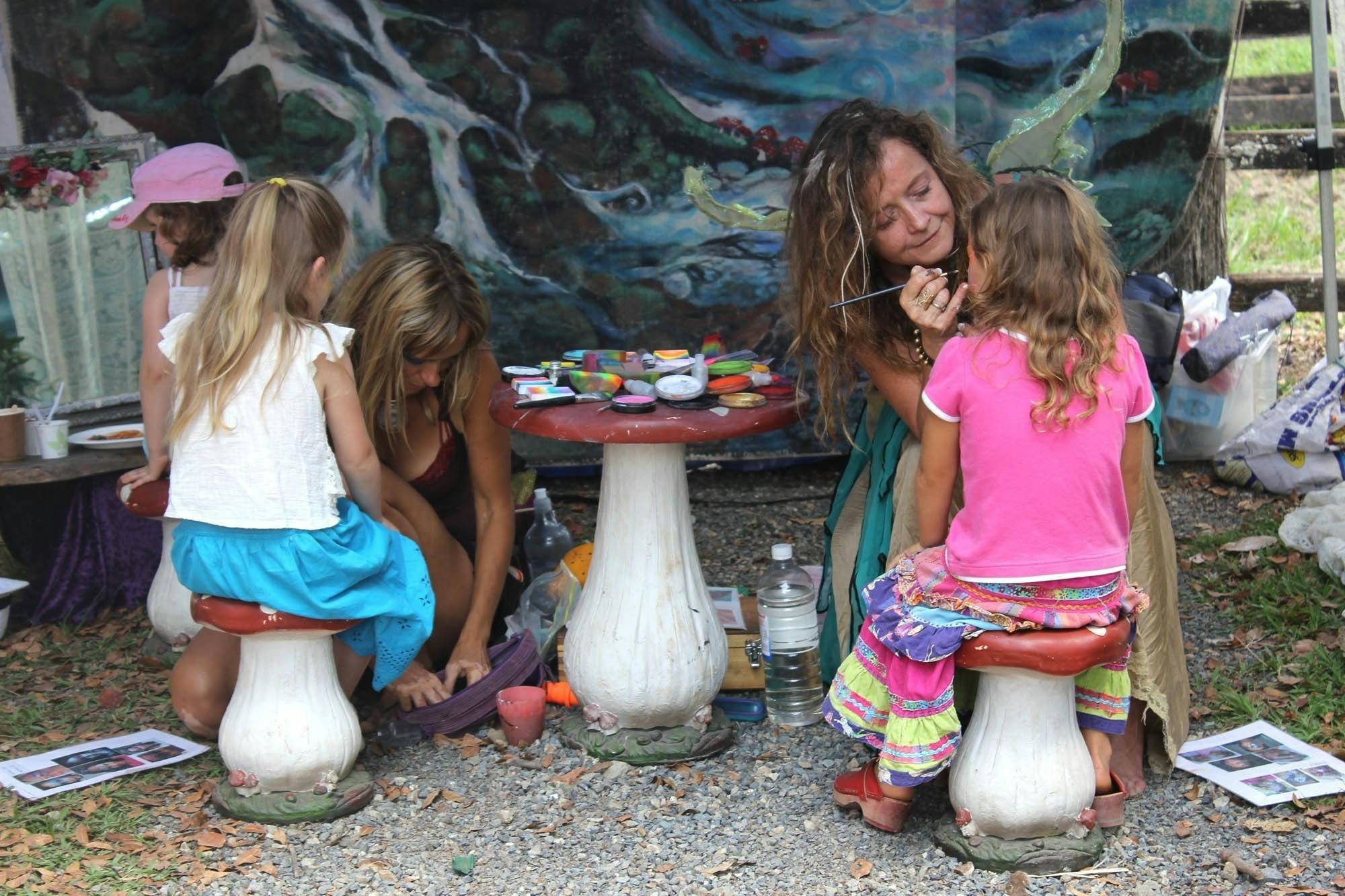 Image of two children getting their face painted