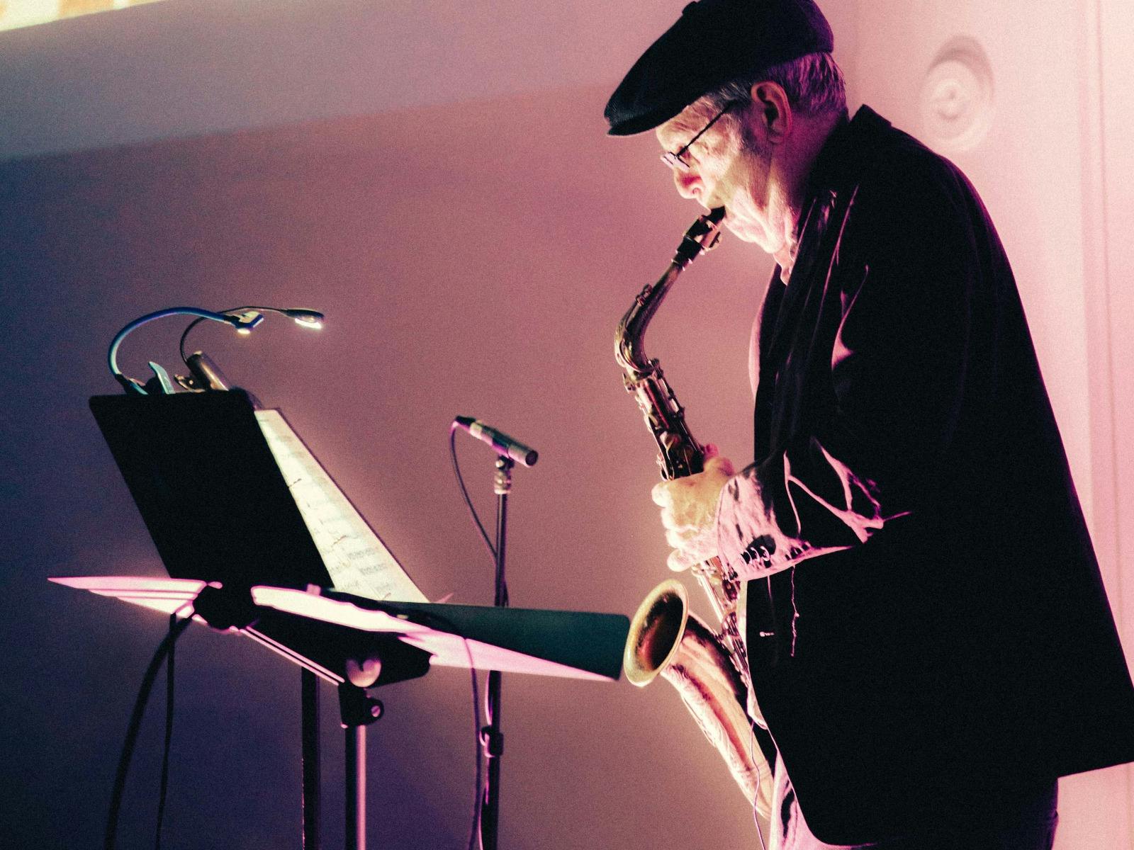 Pictured is Phillip Johnston performing with his saxophone