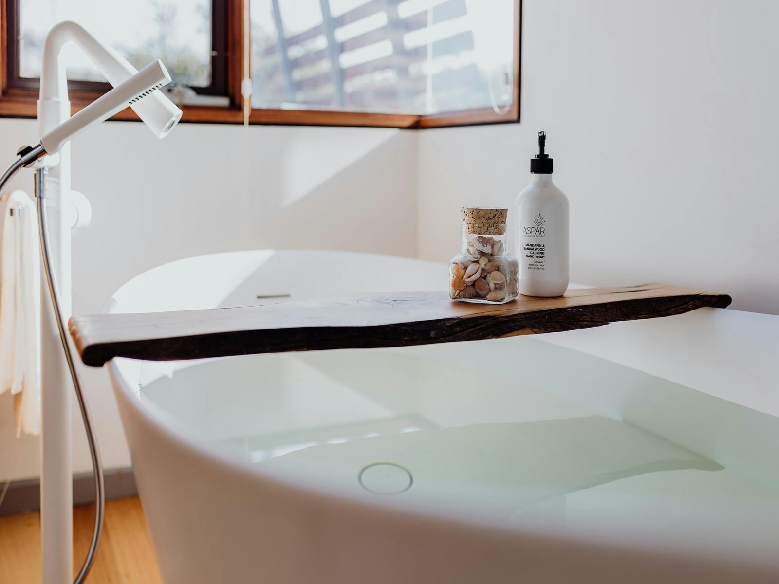 Master bathroom with luxurious bath tub and spa products.