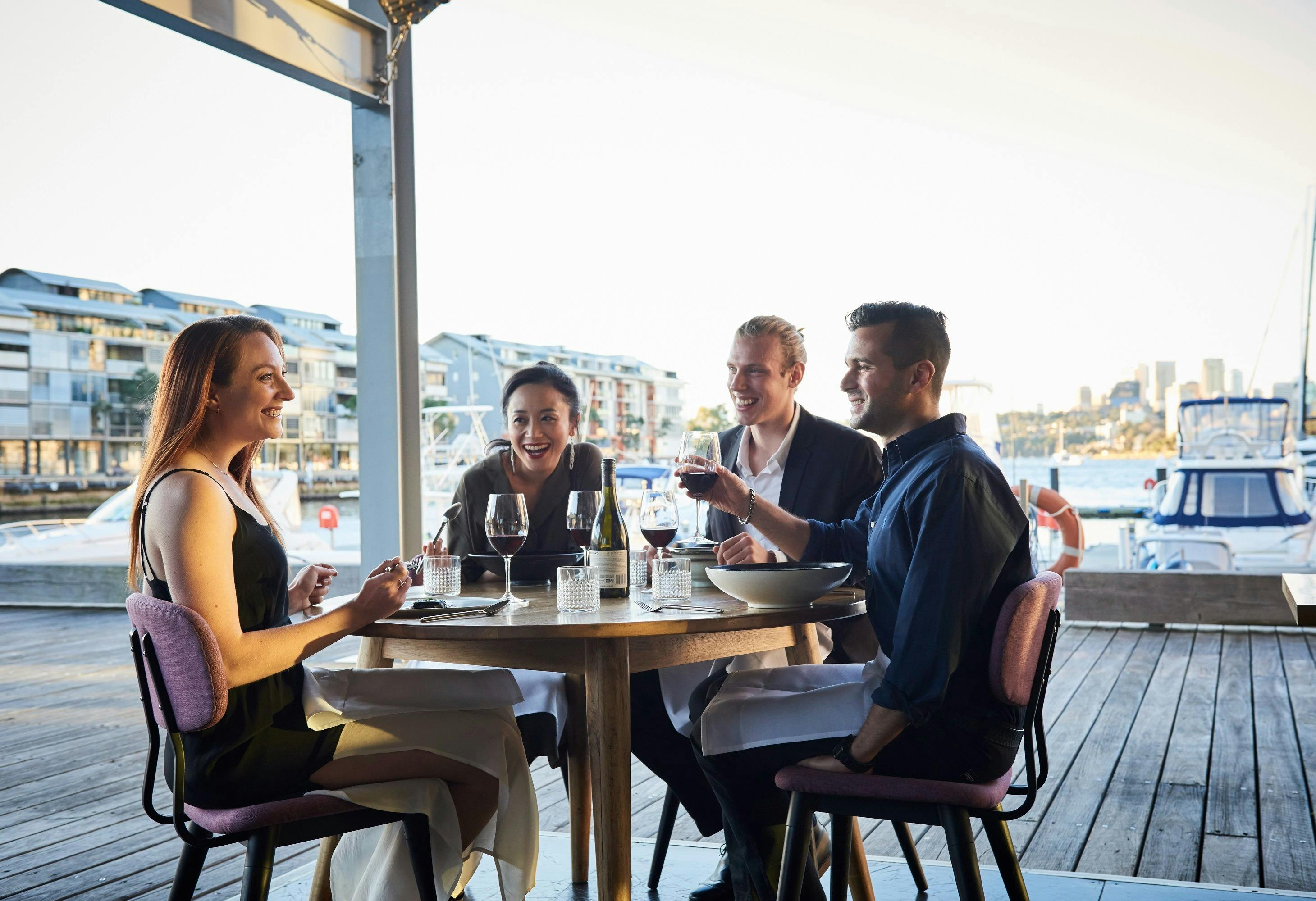 Friends enjoying food and drink at waterside restaurant LuMi Bar & Dining, Pyrmont