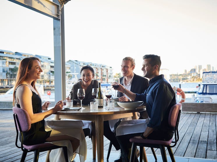 Friends enjoying food and drink at waterside restaurant LuMi Bar & Dining, Pyrmont