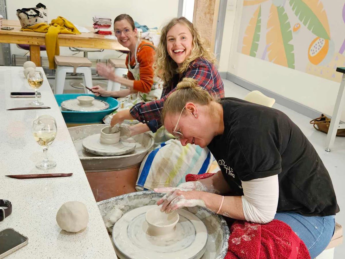 Students at the pottery wheel at Earth & Fire Studio
