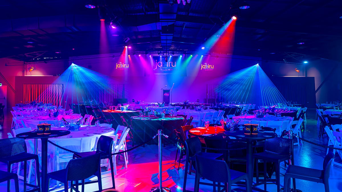 Jabiru Events Centre stage lit with colourful spot and follow lights.