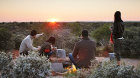 When sunrise comes watch the distant domes of Kata Tjuta come into view.