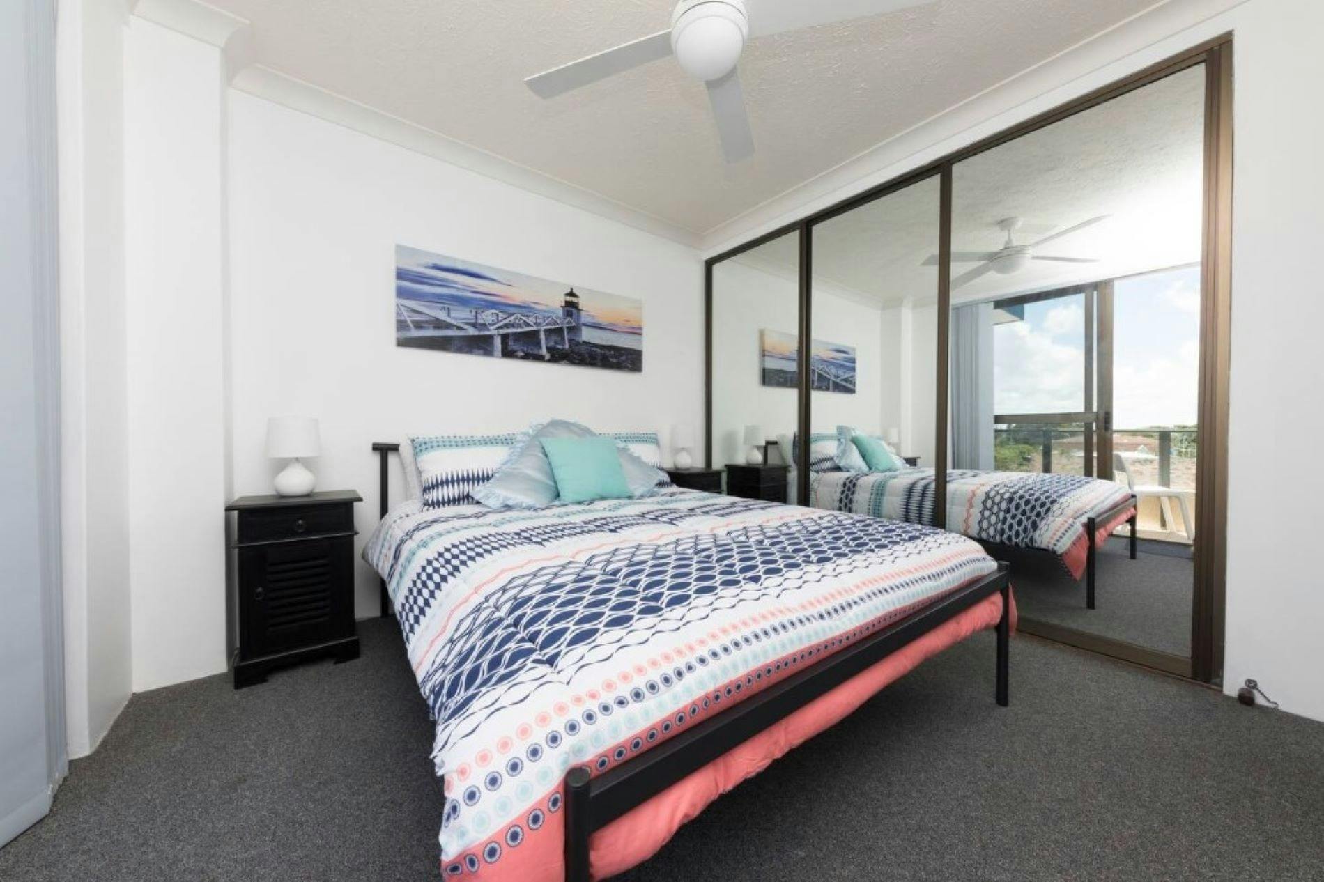 Bedroom with ceiling fan and built in wardrobe