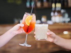 Close up of two hands holding drinks