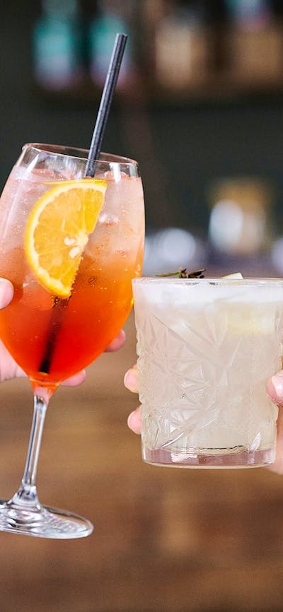 Close up of two hands holding drinks