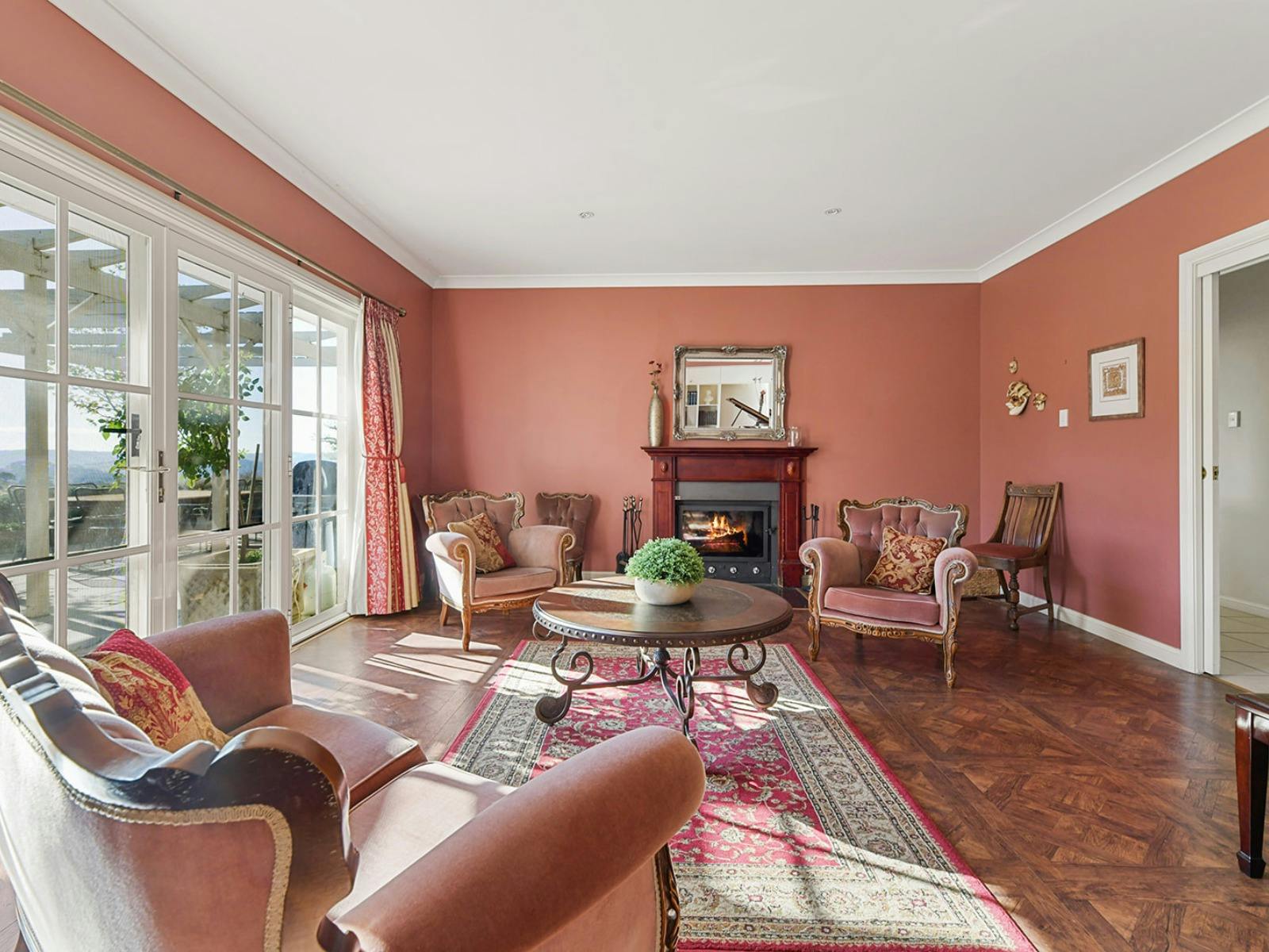 Pink walls, pink furniture and pink rug in the piano room