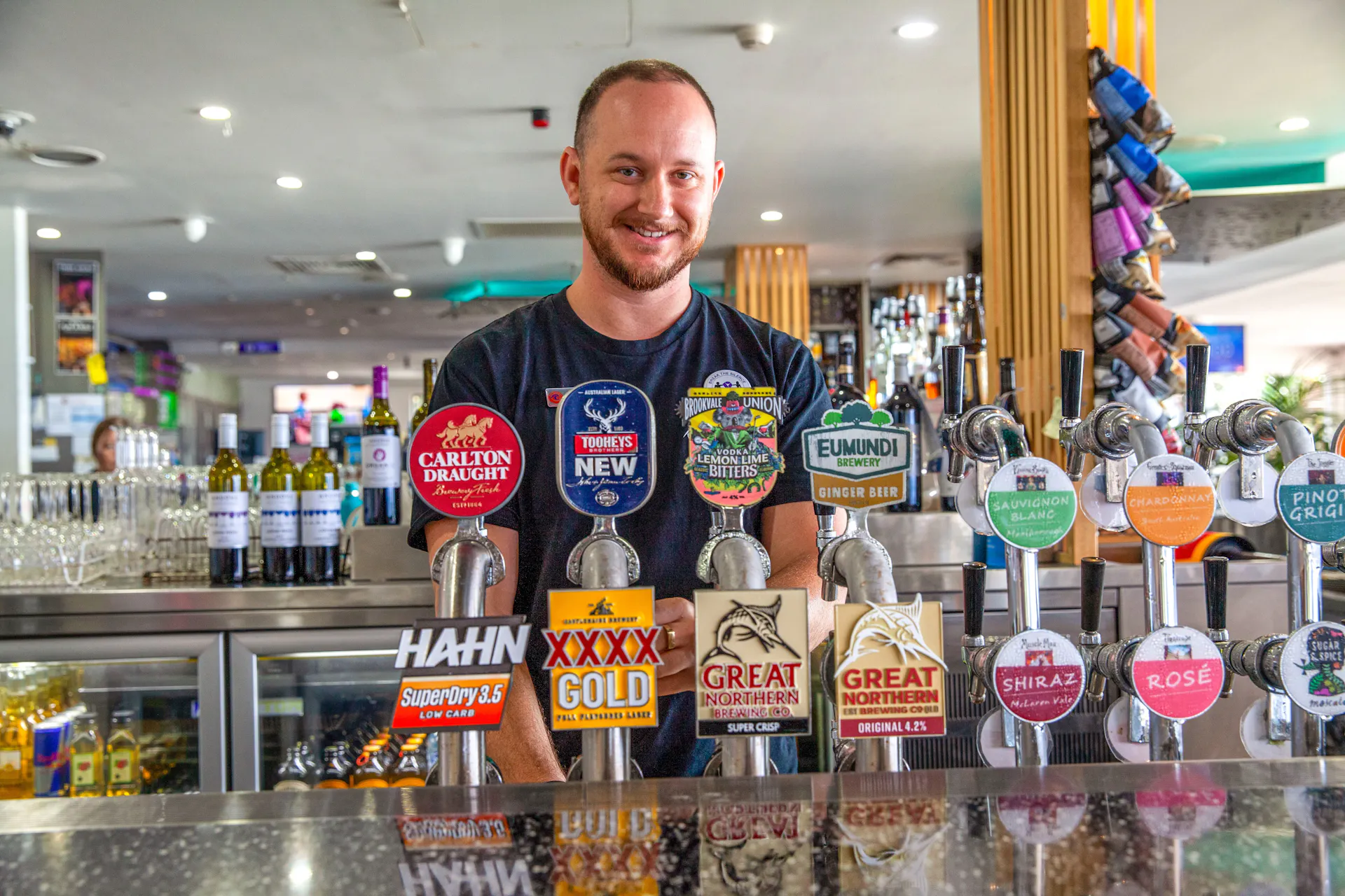 Photo of friendly bar tender serving delicious cold drinks at Coolum Surf Club
