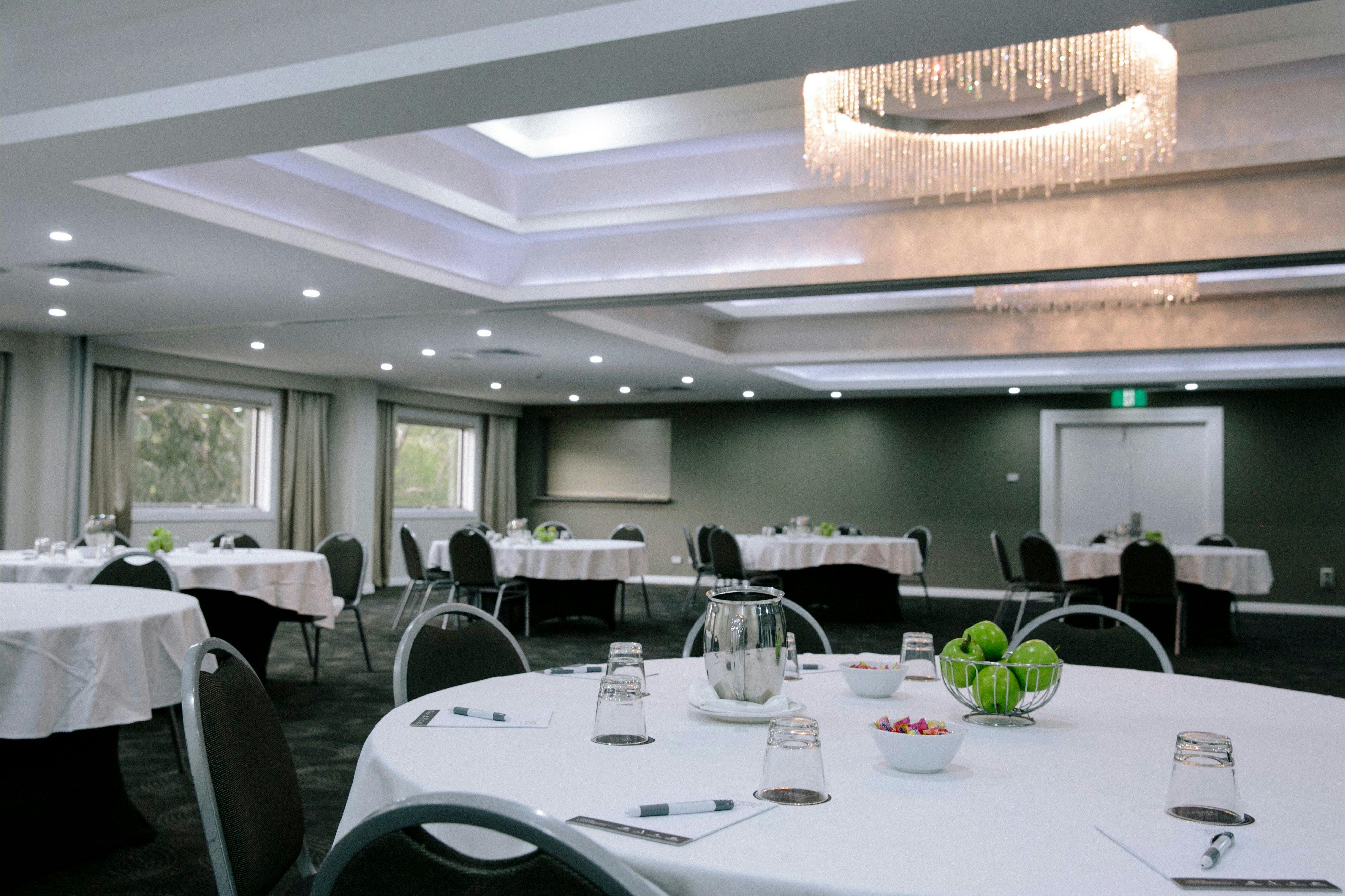 A large airy room full of lush green trees and plants at hotel in Canberra