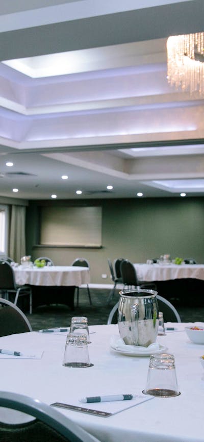 A large airy room full of lush green trees and plants at hotel in Canberra