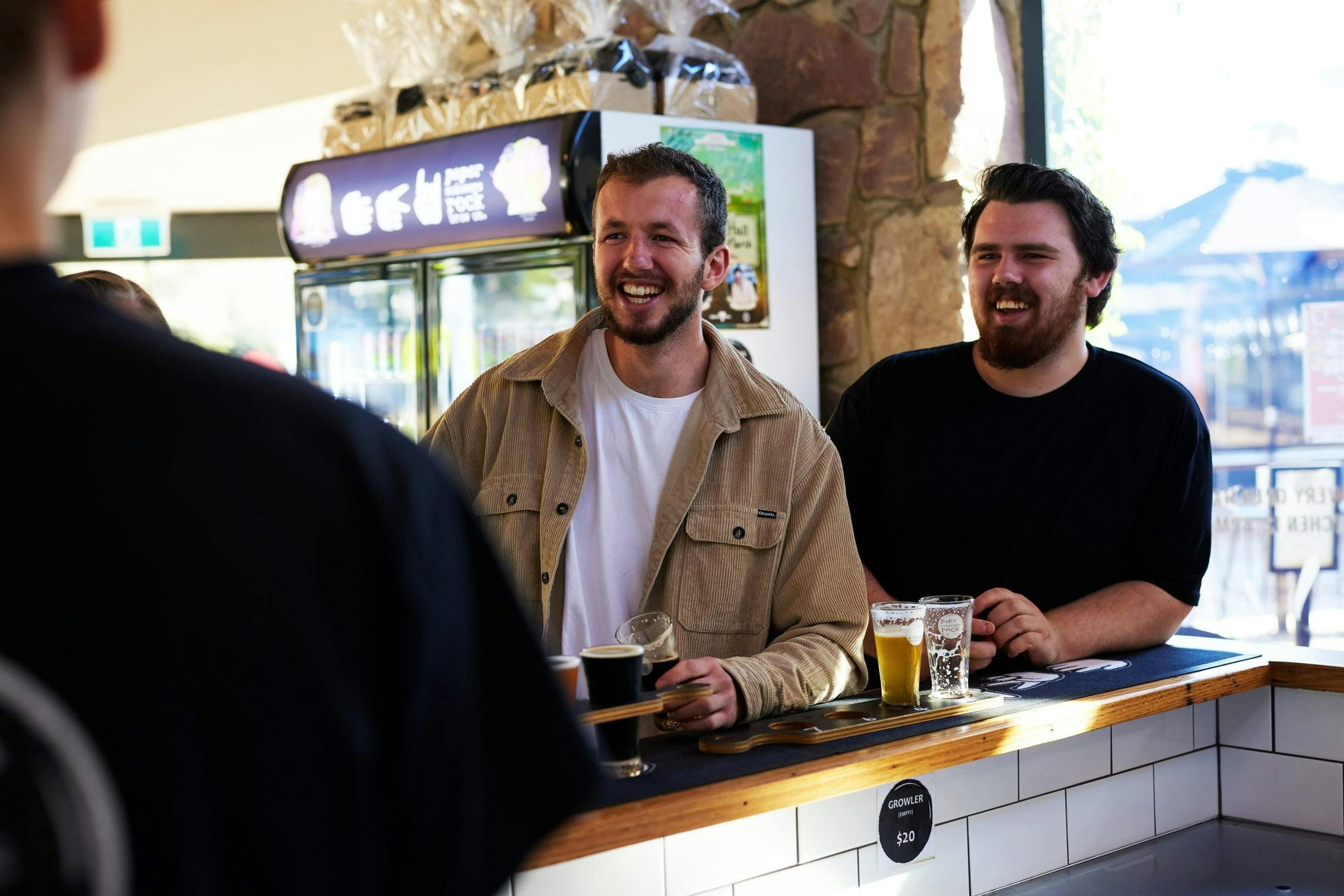 People ordering beers at the bar