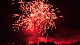 Skies light up red as visitors enjoy the fireworks