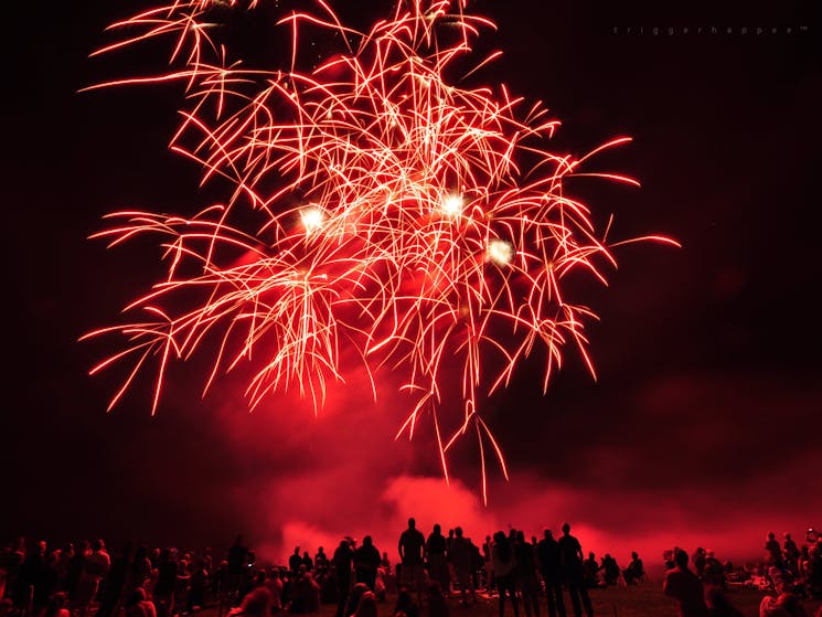 Skies light up red as visitors enjoy the fireworks