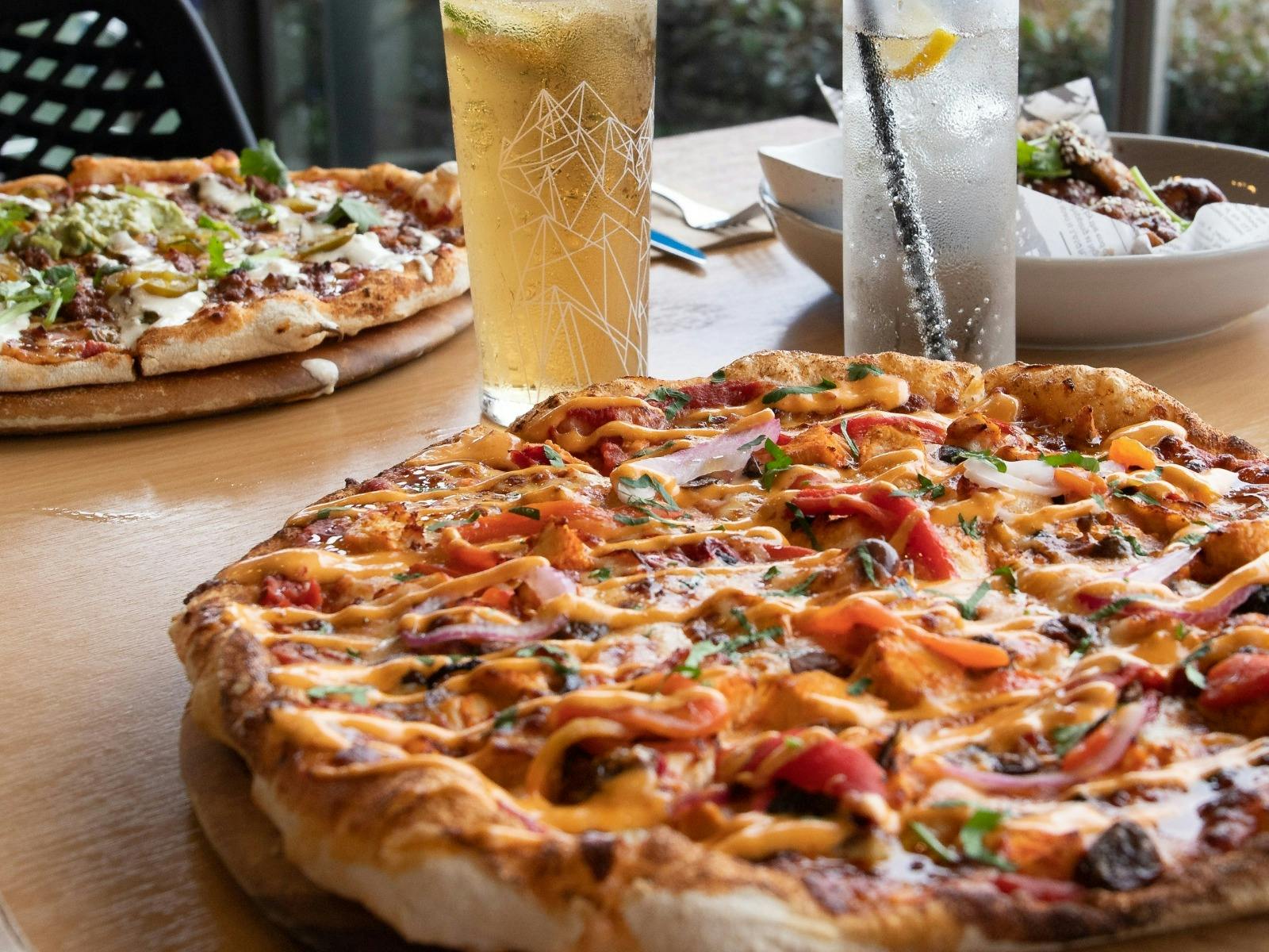 Pizza and drinks on the Balcony at Tradies Helensburgh
