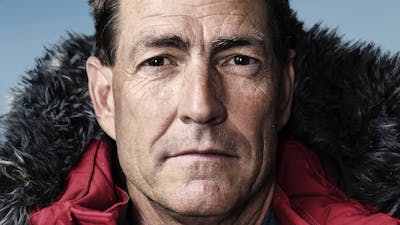 Headshot of Professor John Priscu in a red, weatherproof jacket with hood,