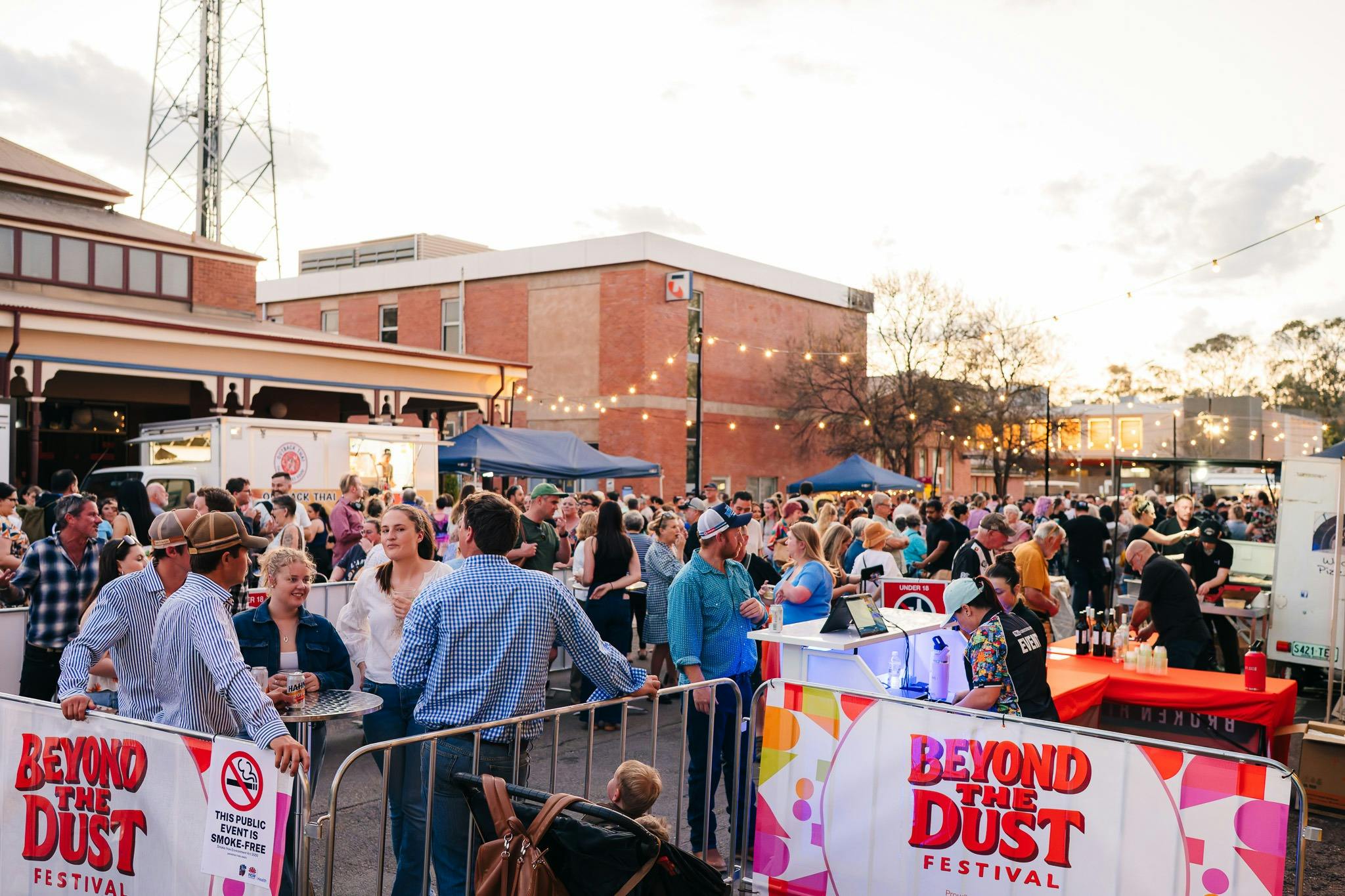 Festival attendees gathering in the Beyond the Dust food court and bar area