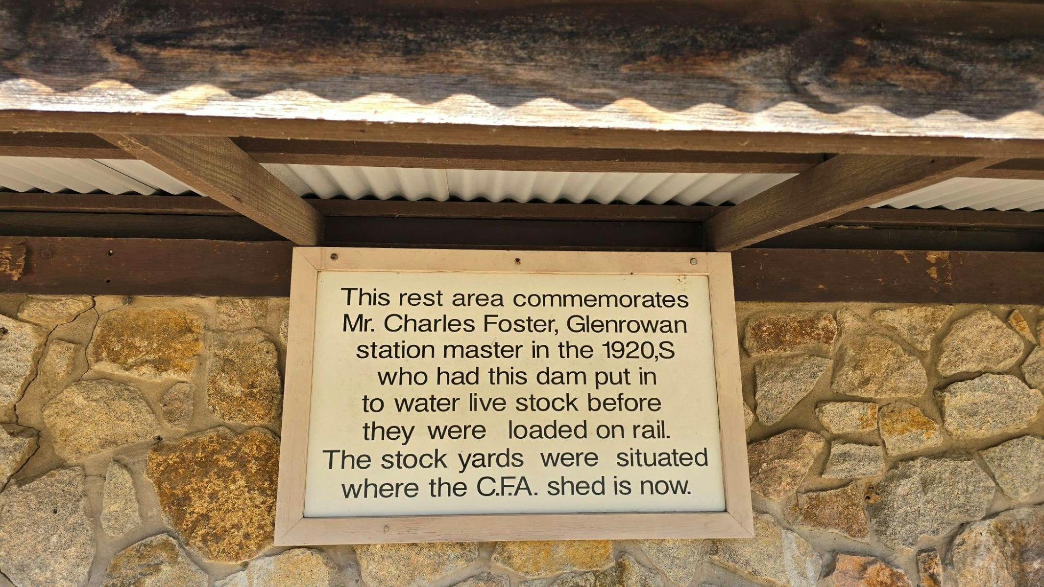 White sign with black writing of information about Fosters Lake