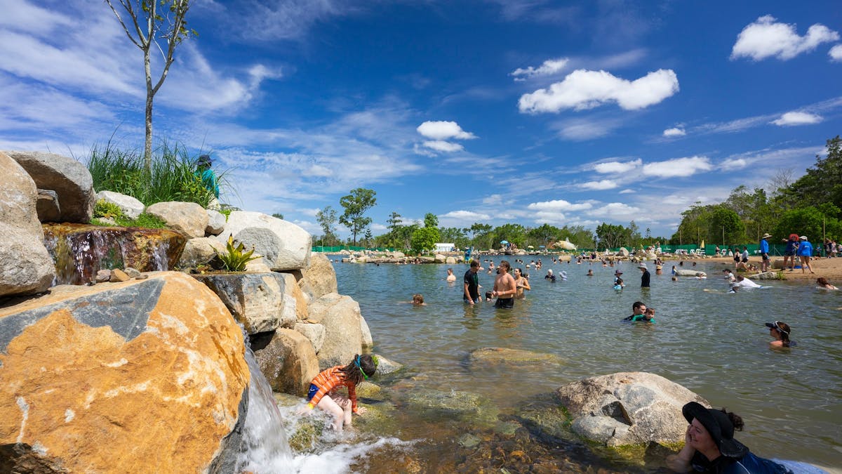 Lake Gkula with swimmers and waterfall