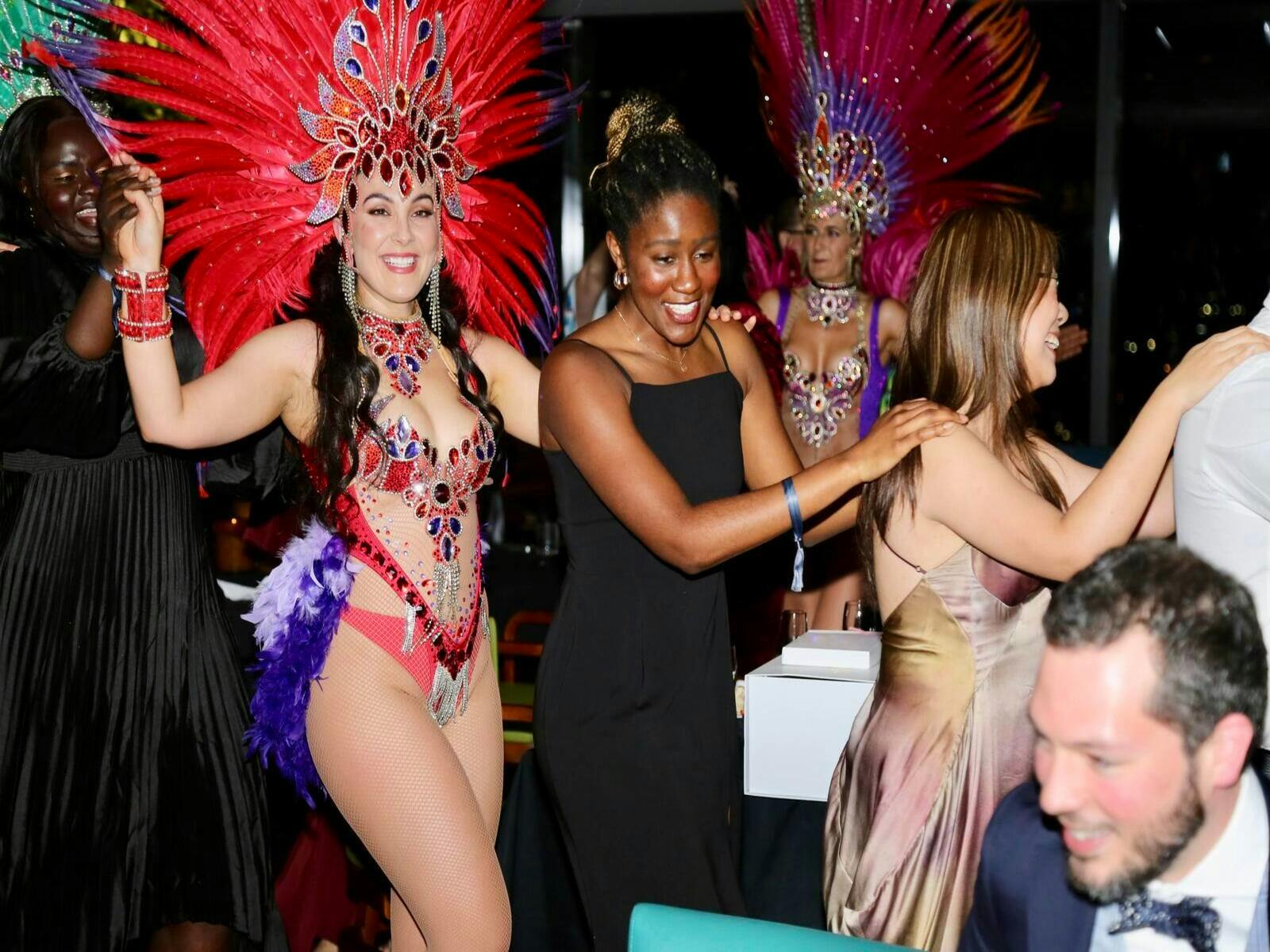 Professionals from diverse backgrounds at a formal gala dinner event.