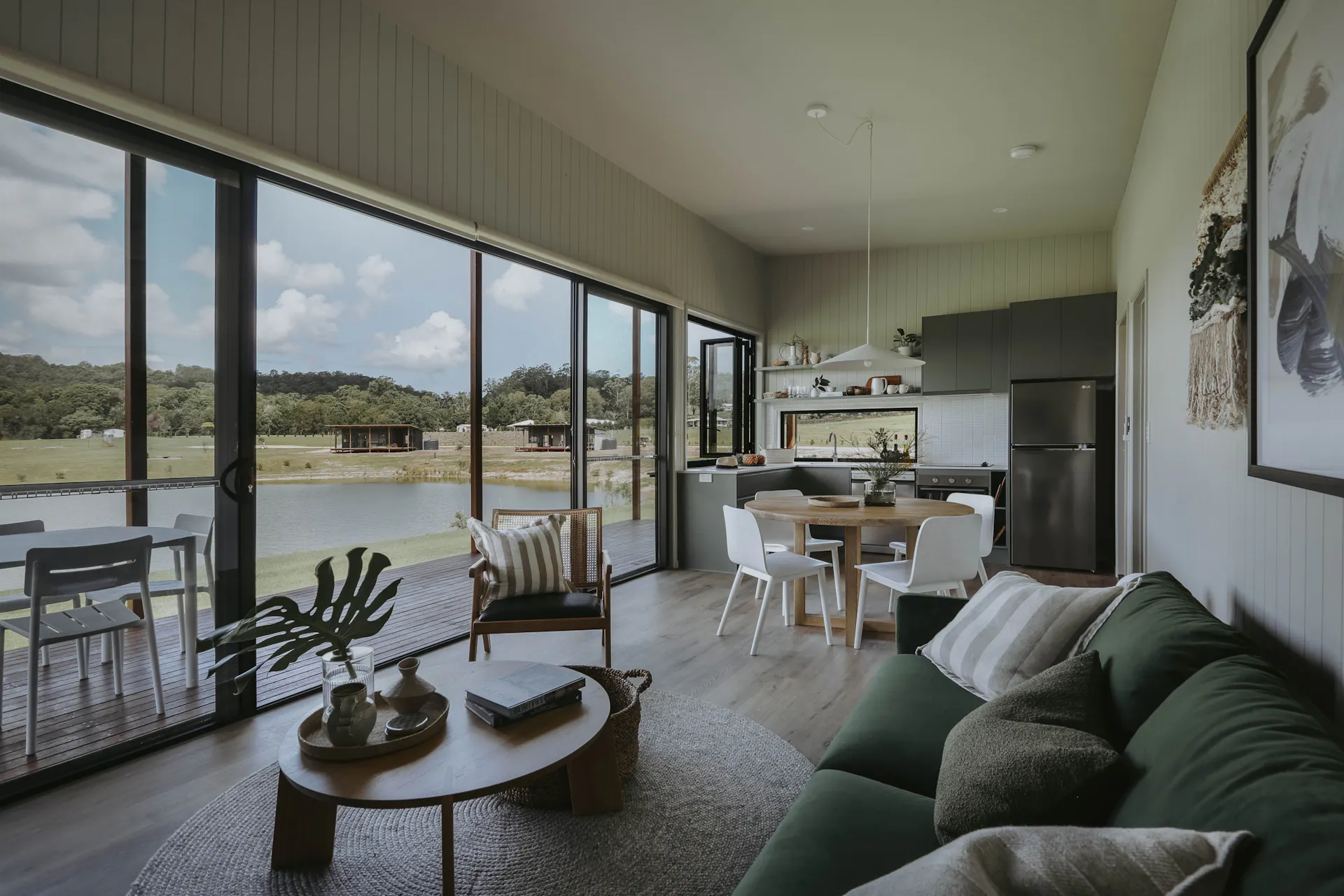 View looking through living room to kitchen and outdoor deck