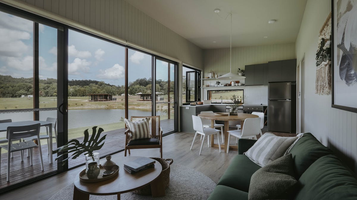 View looking through living room to kitchen and outdoor deck