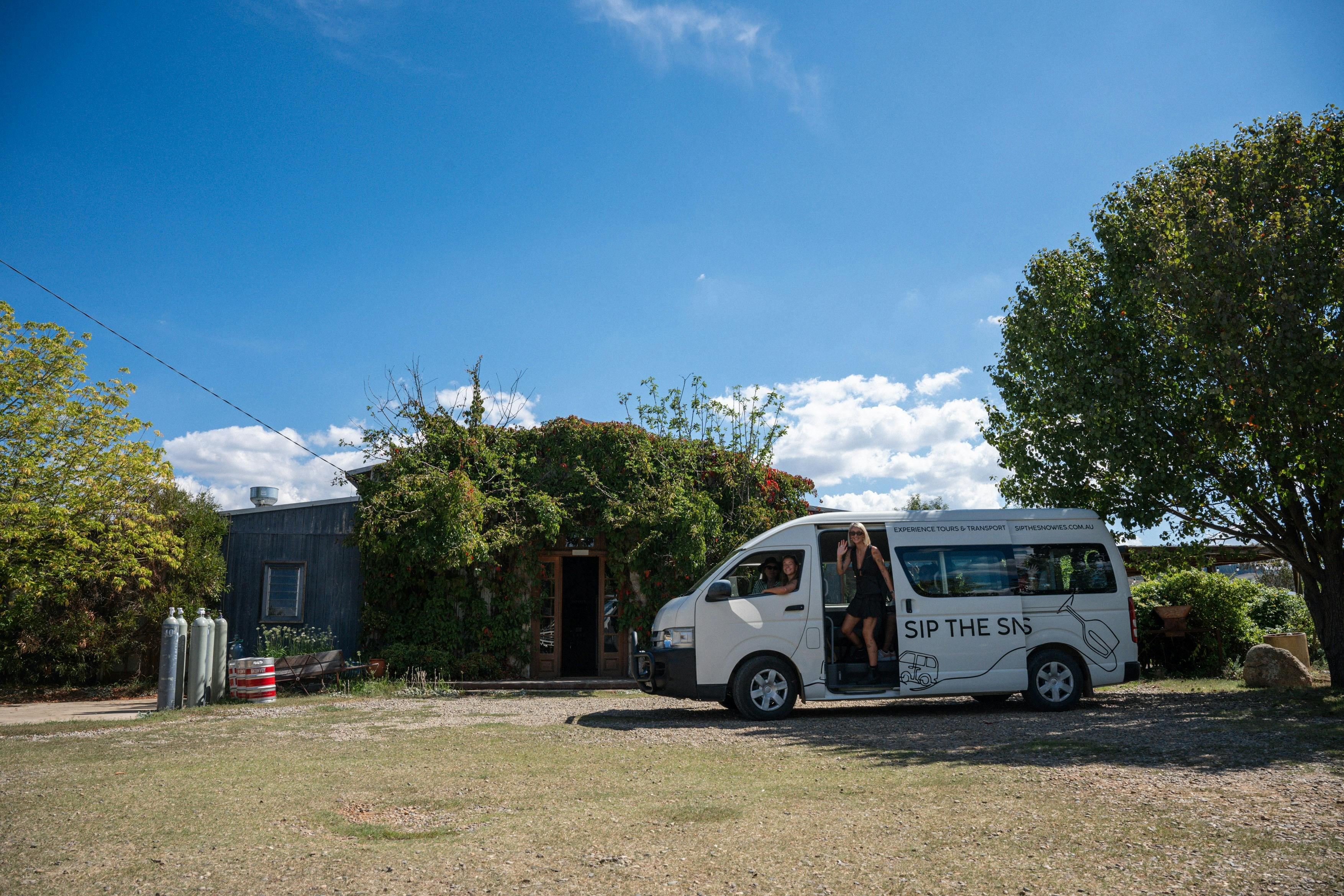 The Sip the Snowies tour bus out the front of Dalgety Brewing Co with a waving guest on board