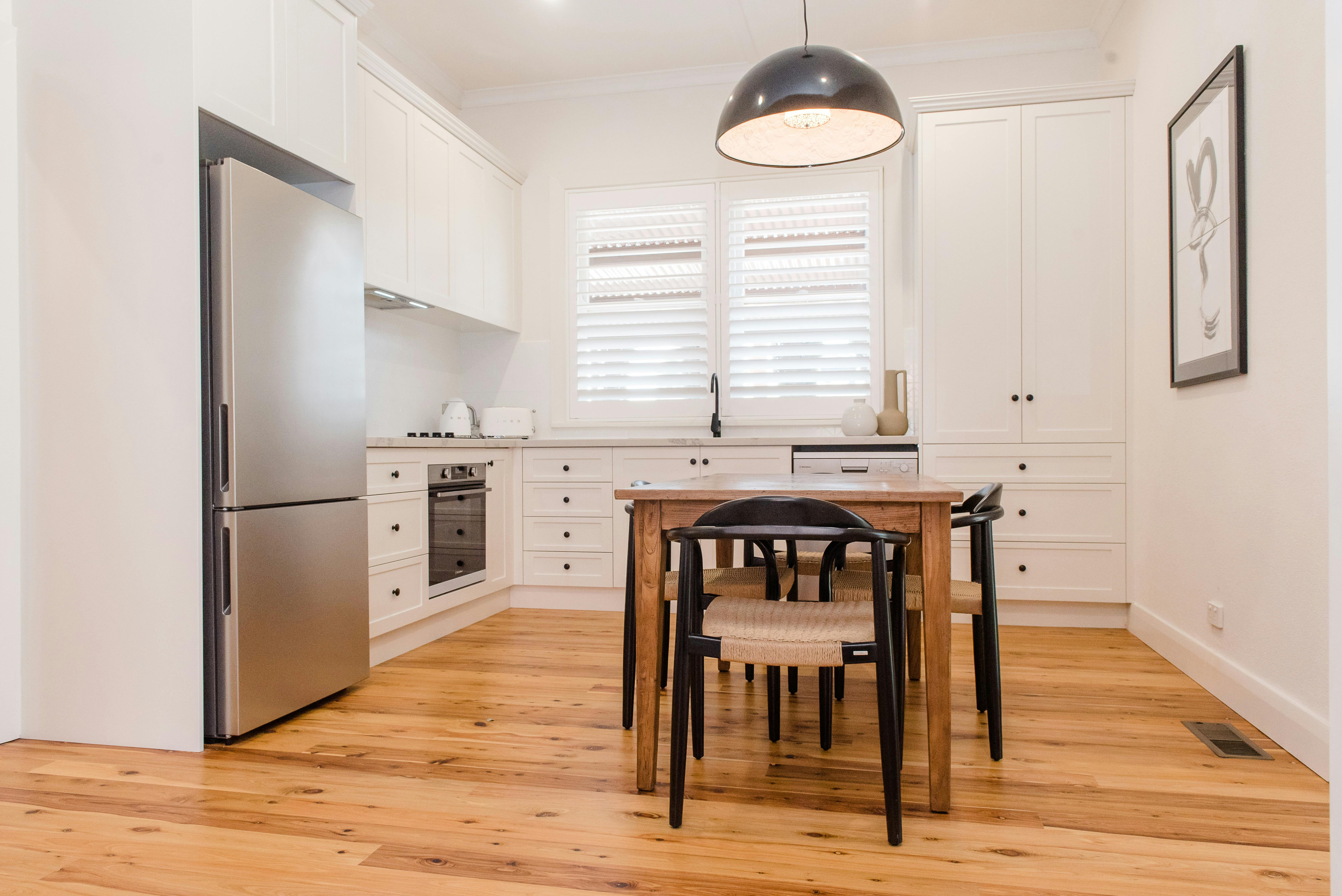 Renovated kitchen with dining table and cooking facillities in townhouse