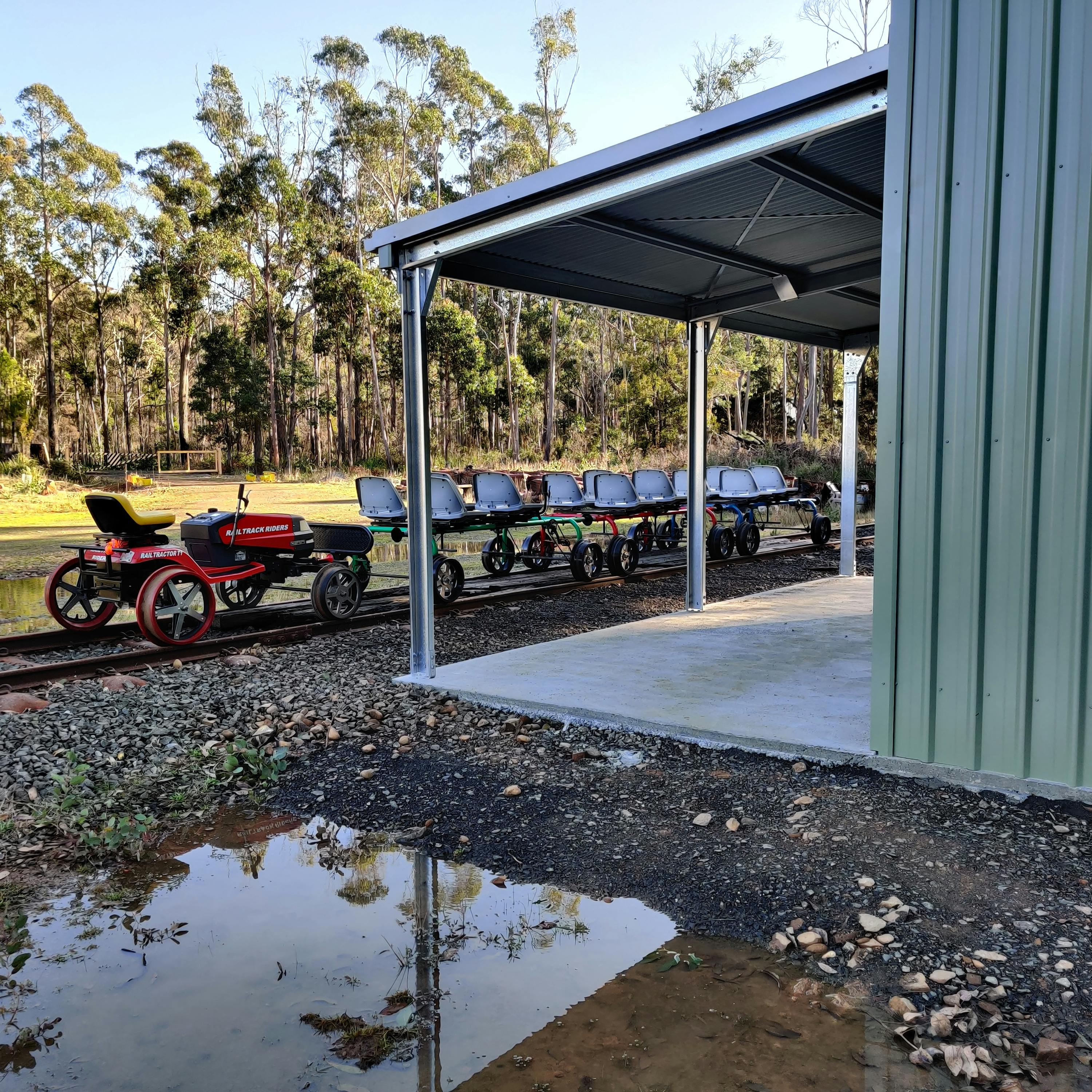 Railbugs  and escort vehicle by the railbug shed.