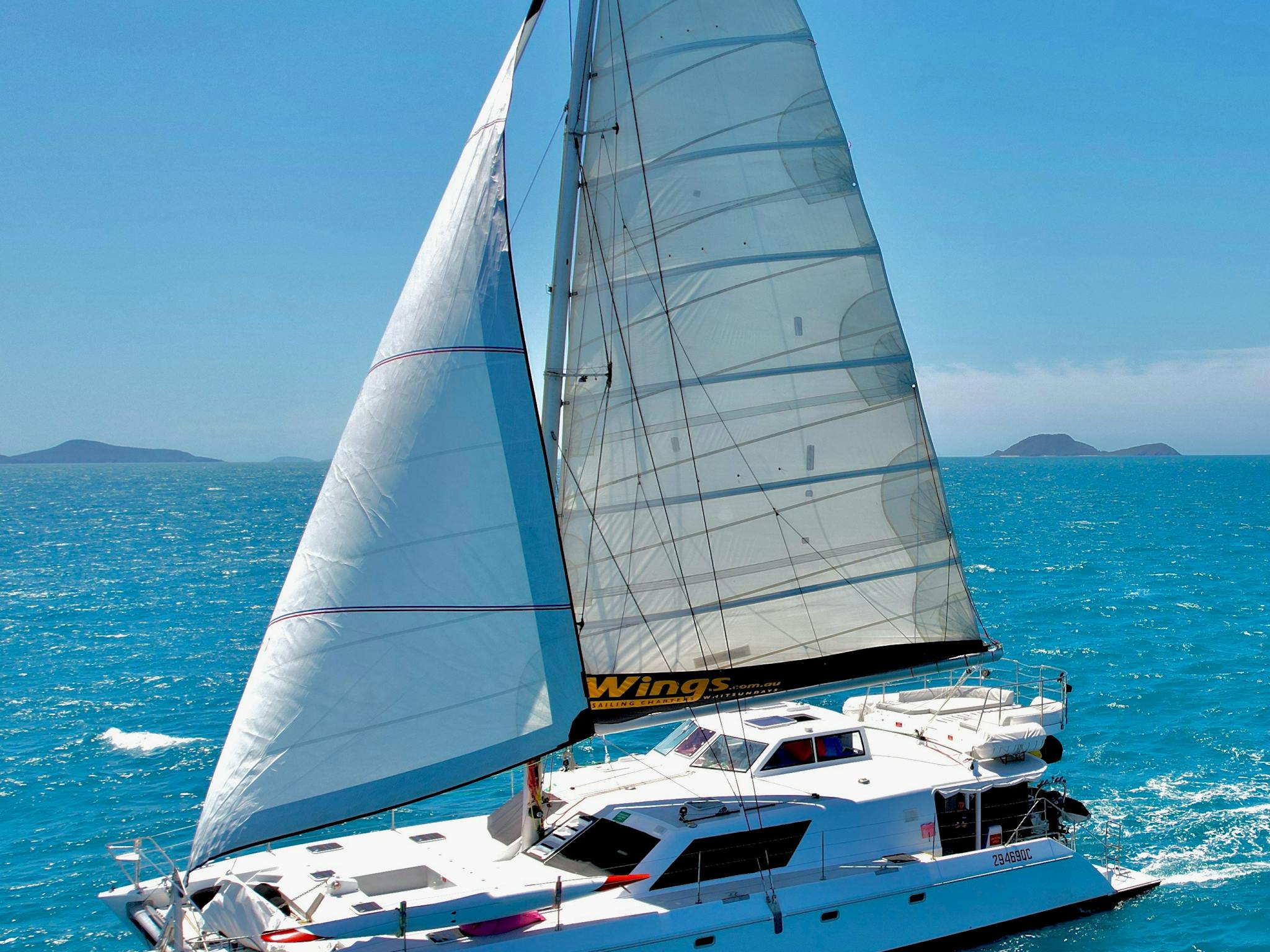 Wings III 60ft sailing catamaran under sail side on Wings III 60ft sailing catamaran under sail side on