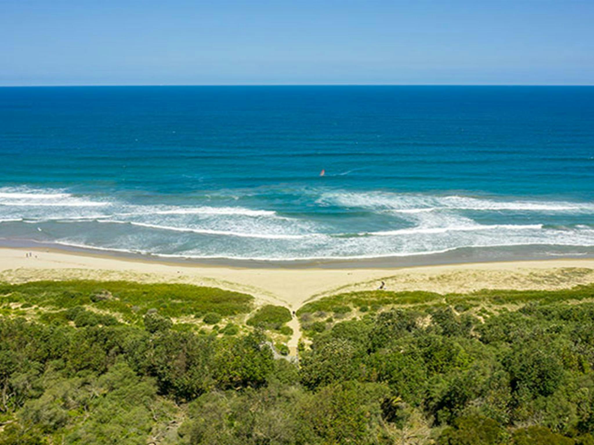 An aerial view of the path to the beach from Beach Road picnic area in Seven Mile Beach National
