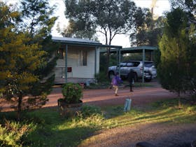 children playing near two-bedroom cabin