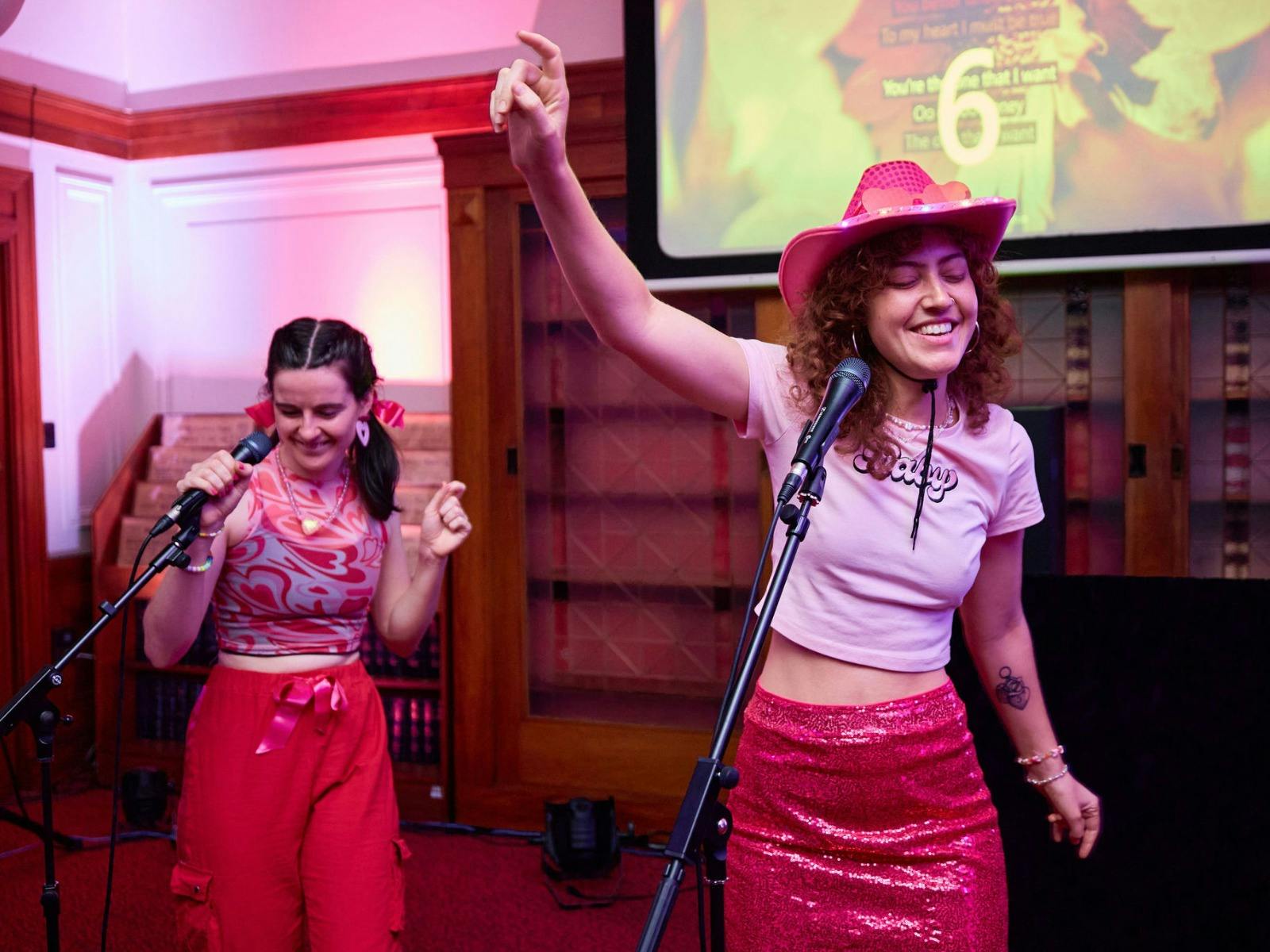 Two girls singing karaoke in Old Parliament House