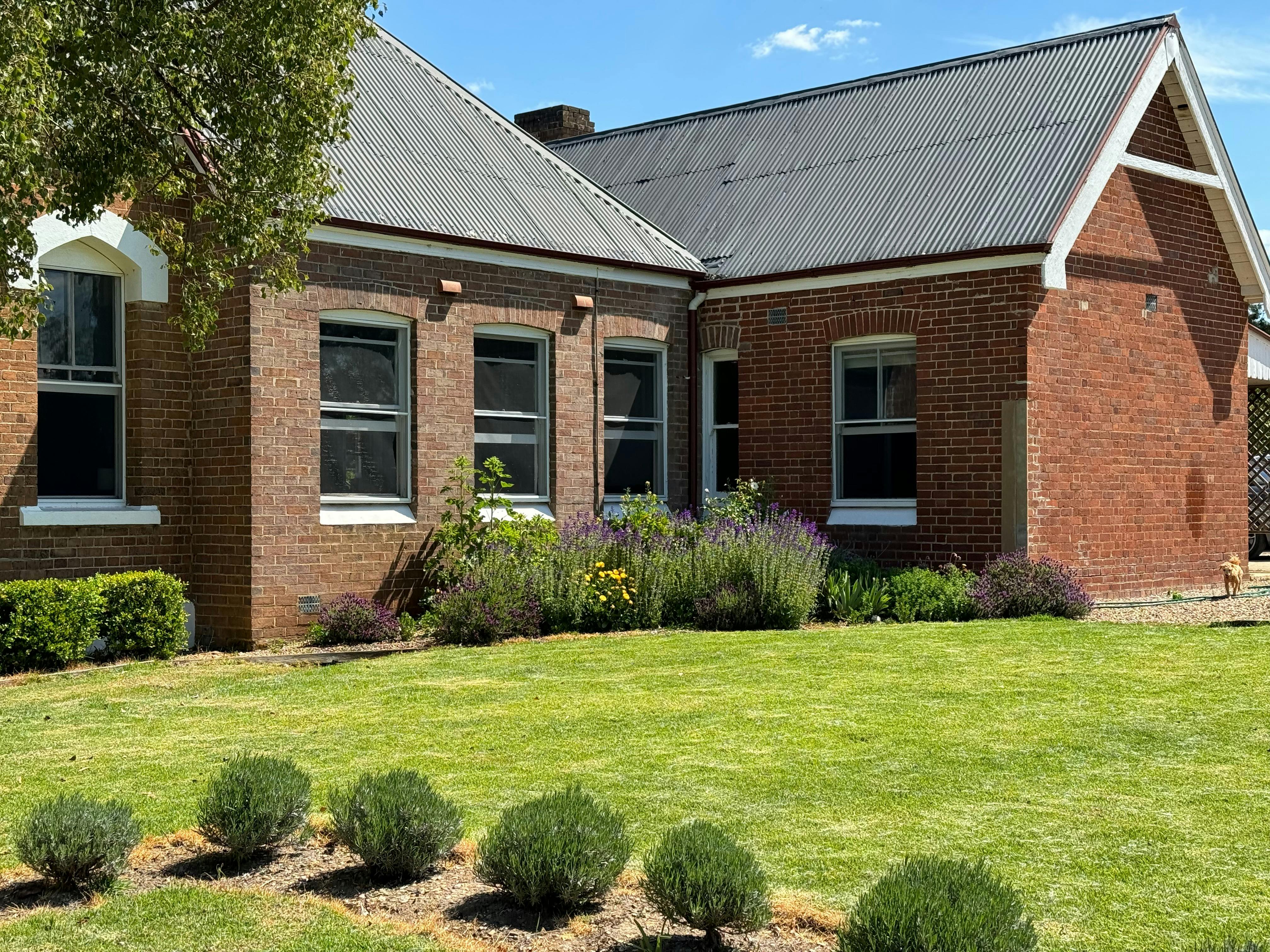 House with lawn and cottage gardens