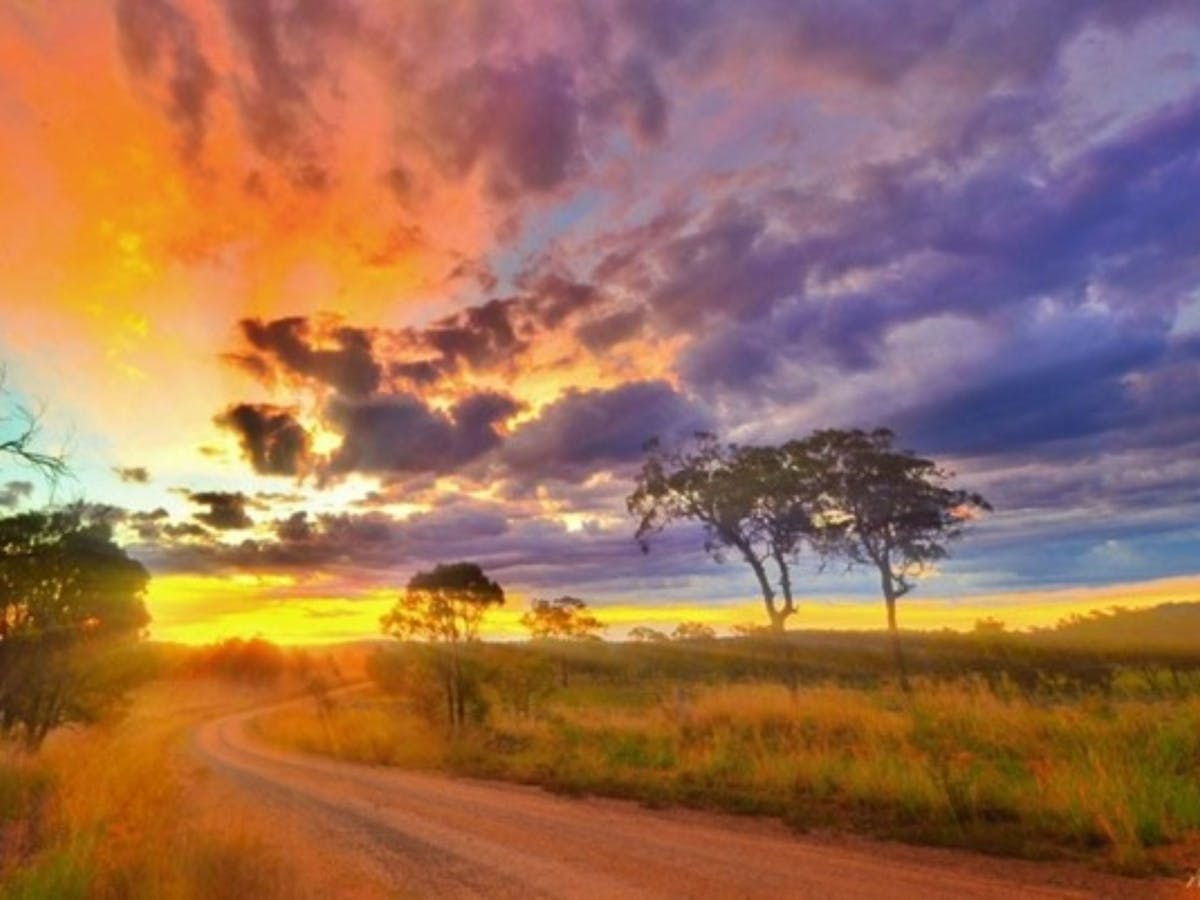 Colourful skyline with sun setting in background