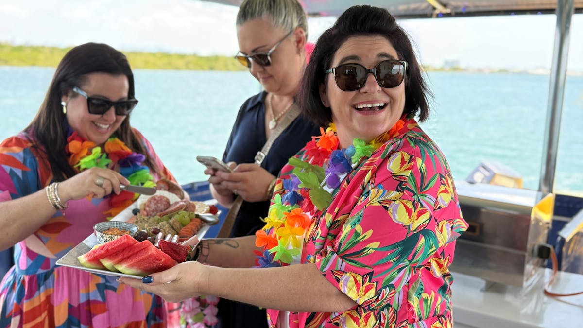 Guests in brightly coloured tropical shirts with grazing platter