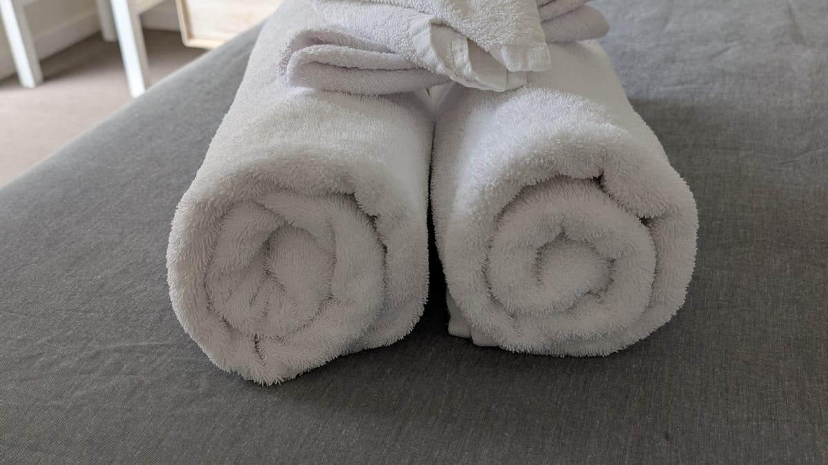 towels rolled on bed
