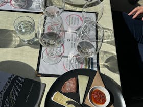 Wine tasting accompanied by a small charcuterie plate at Mount Majura Vineyard