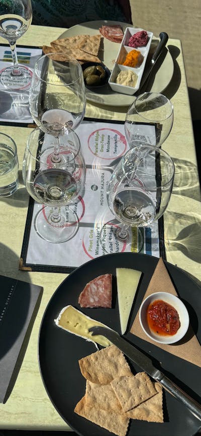 Wine tasting accompanied by a small charcuterie plate at Mount Majura Vineyard