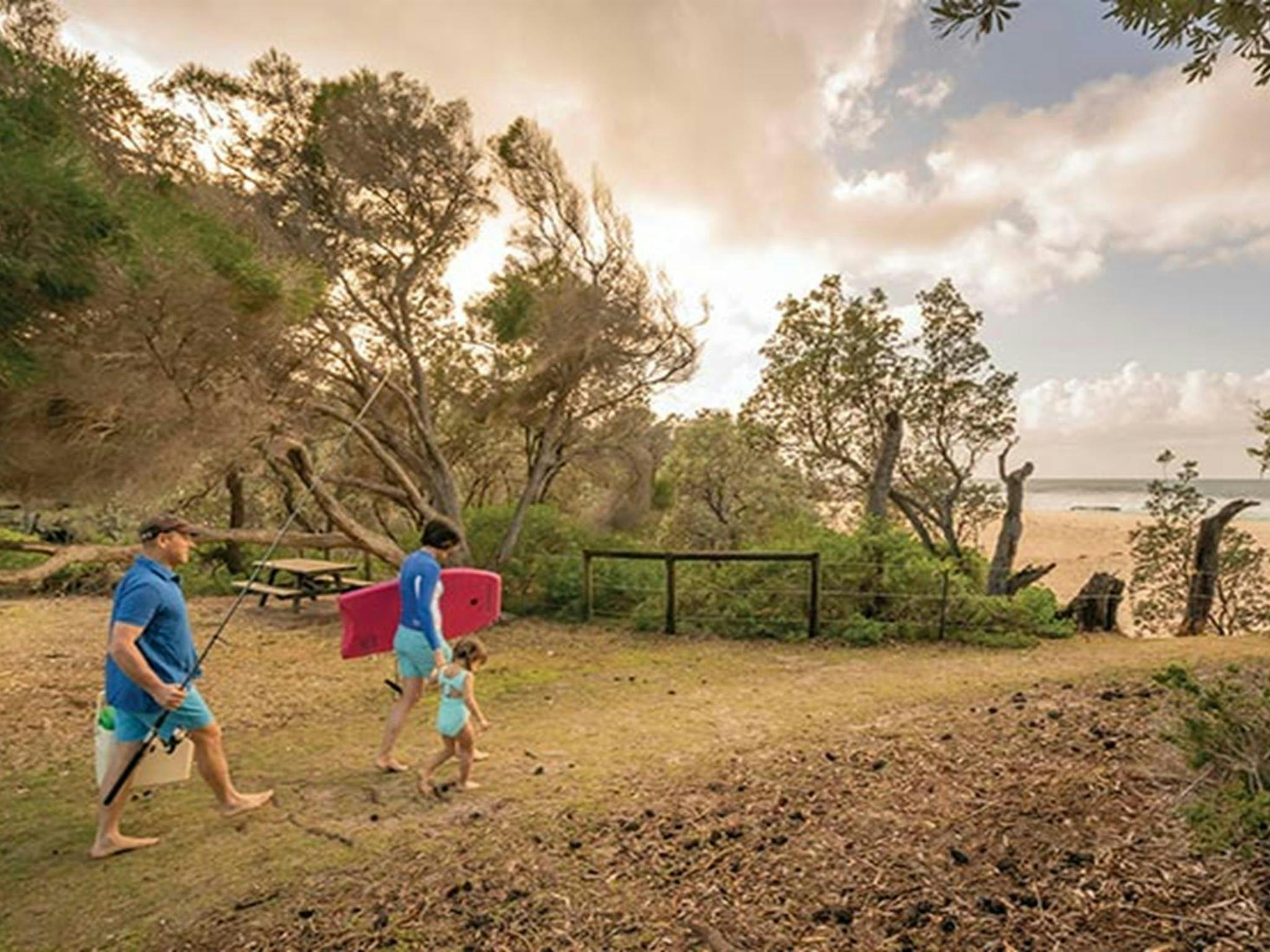 Family at Haycock Point picnic area, walking to the nearby beach. Photo: John Spencer/DPIE