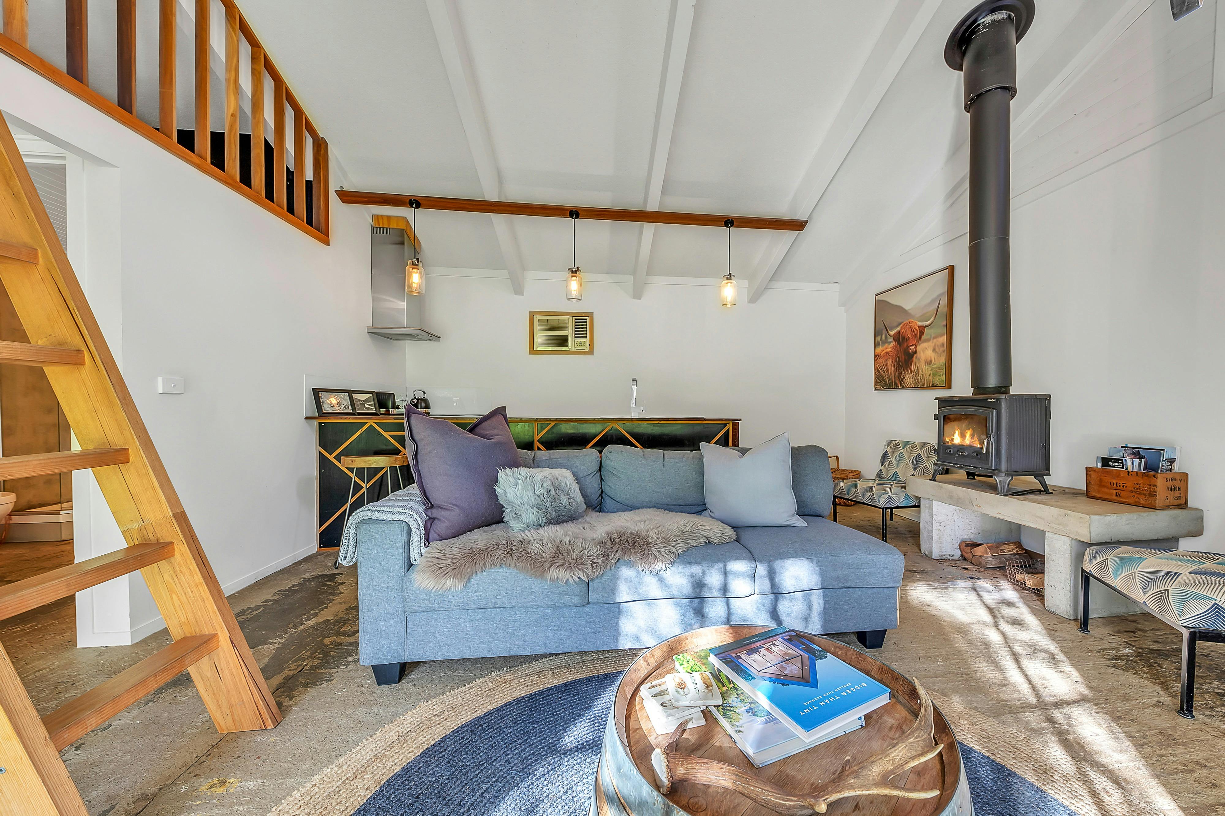 Lounge area with a sofa and tea table, fireplace in the corner