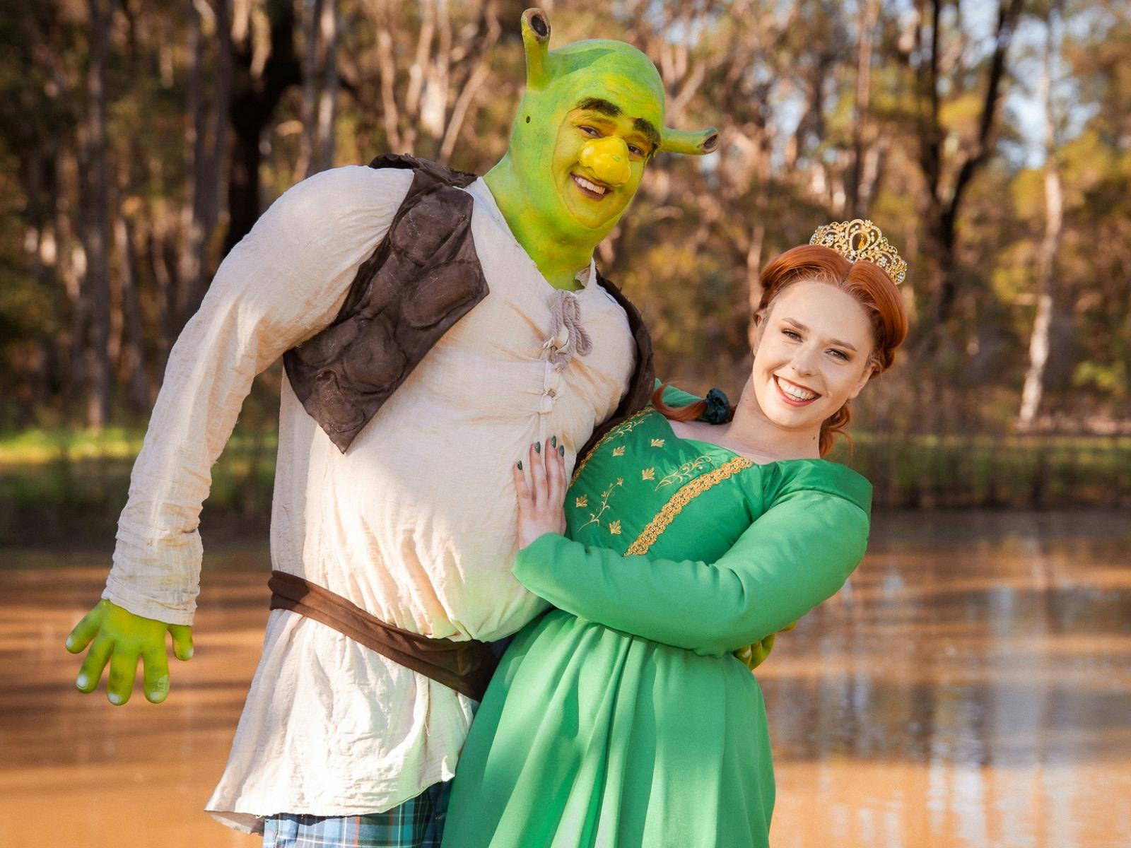 Shrek dipping Fiona in front of his swamp