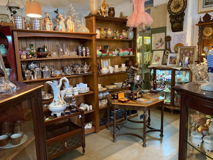 Open shelves house everything from pottery to silverware and small furniture holds many treasures