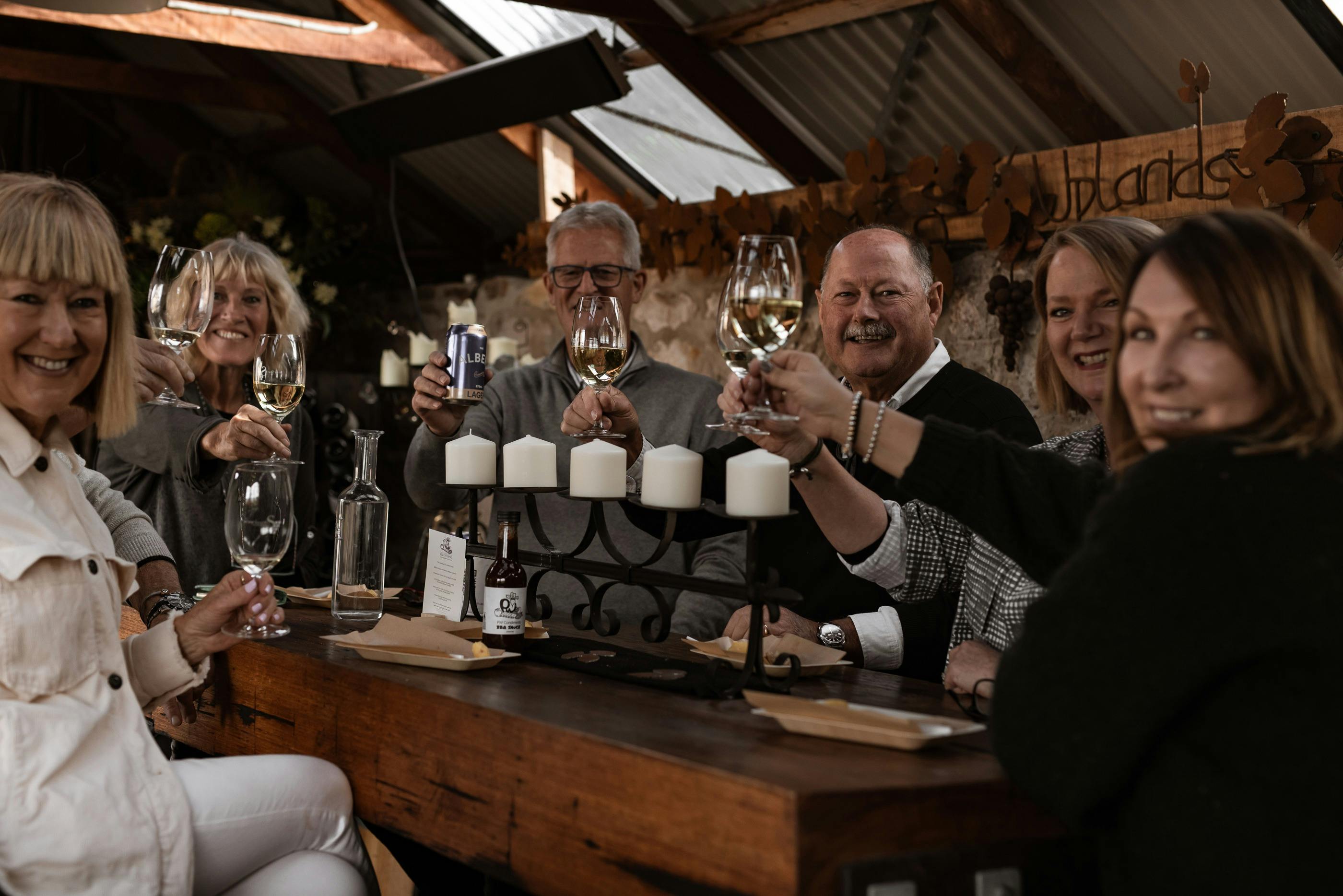 Visitors cheering on with wine in shed