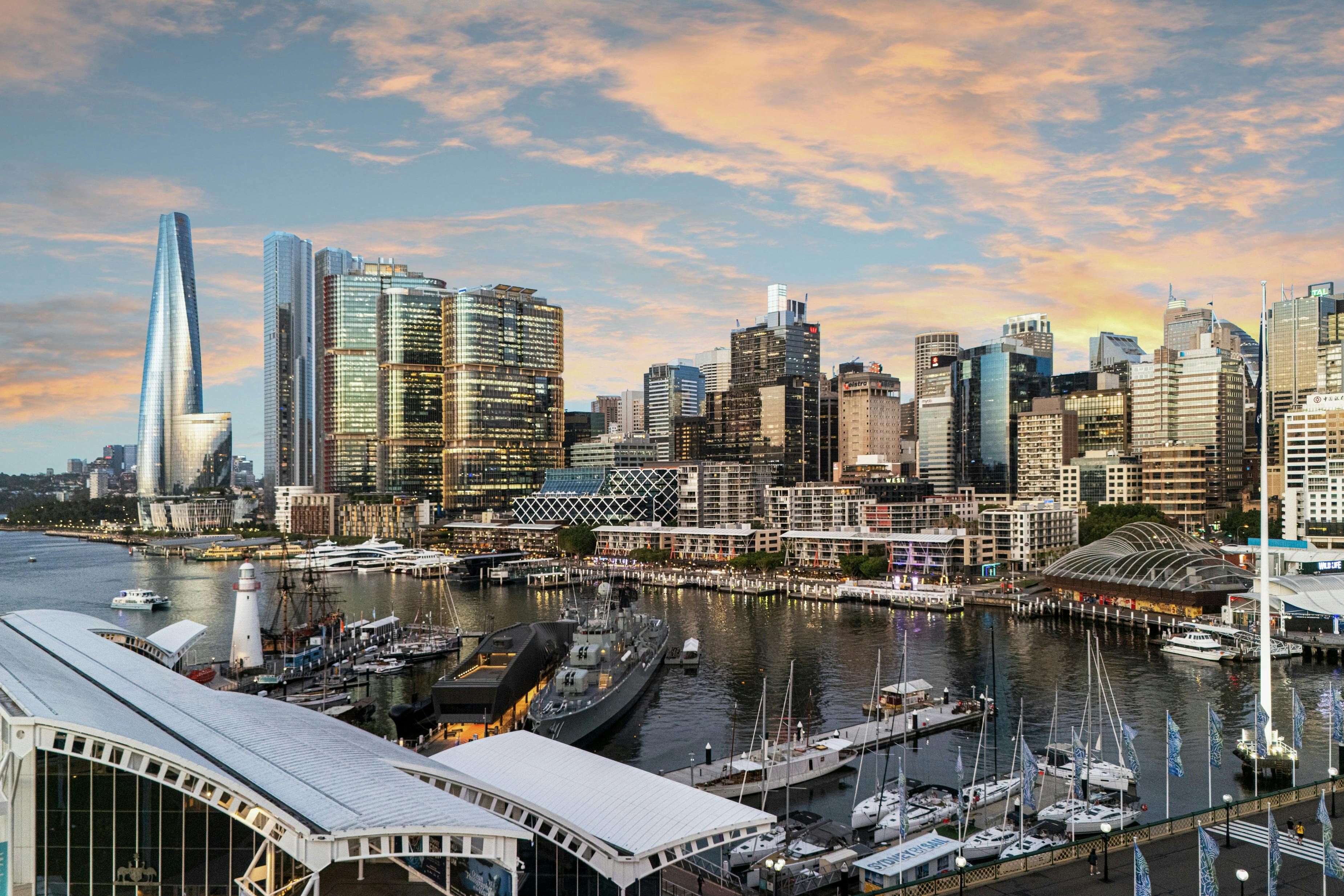 Sunset view over Darling Harbour in Sydney with waterfront boats, marina, and city skyline