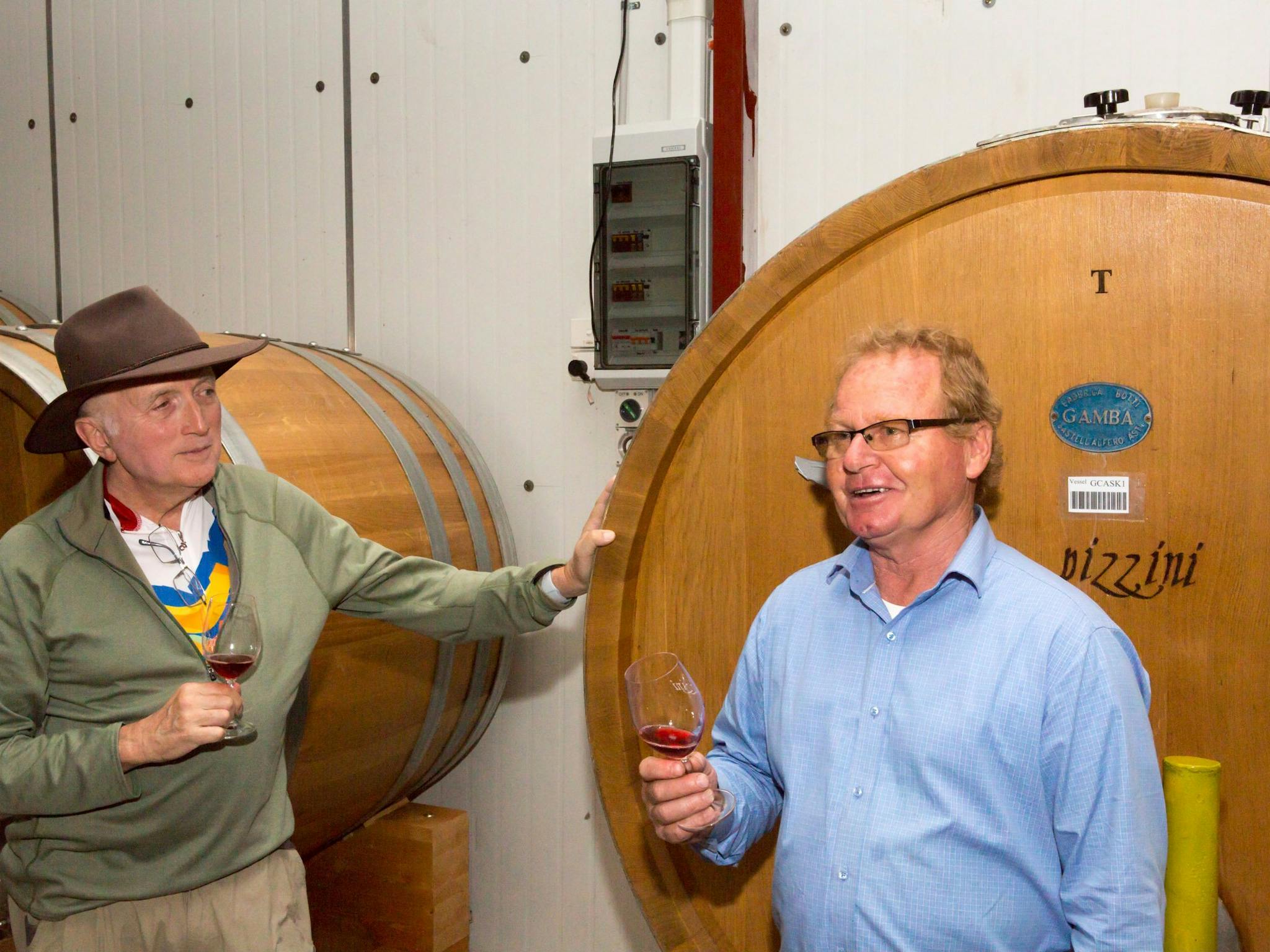 two men discuss the merits of a glass of wine